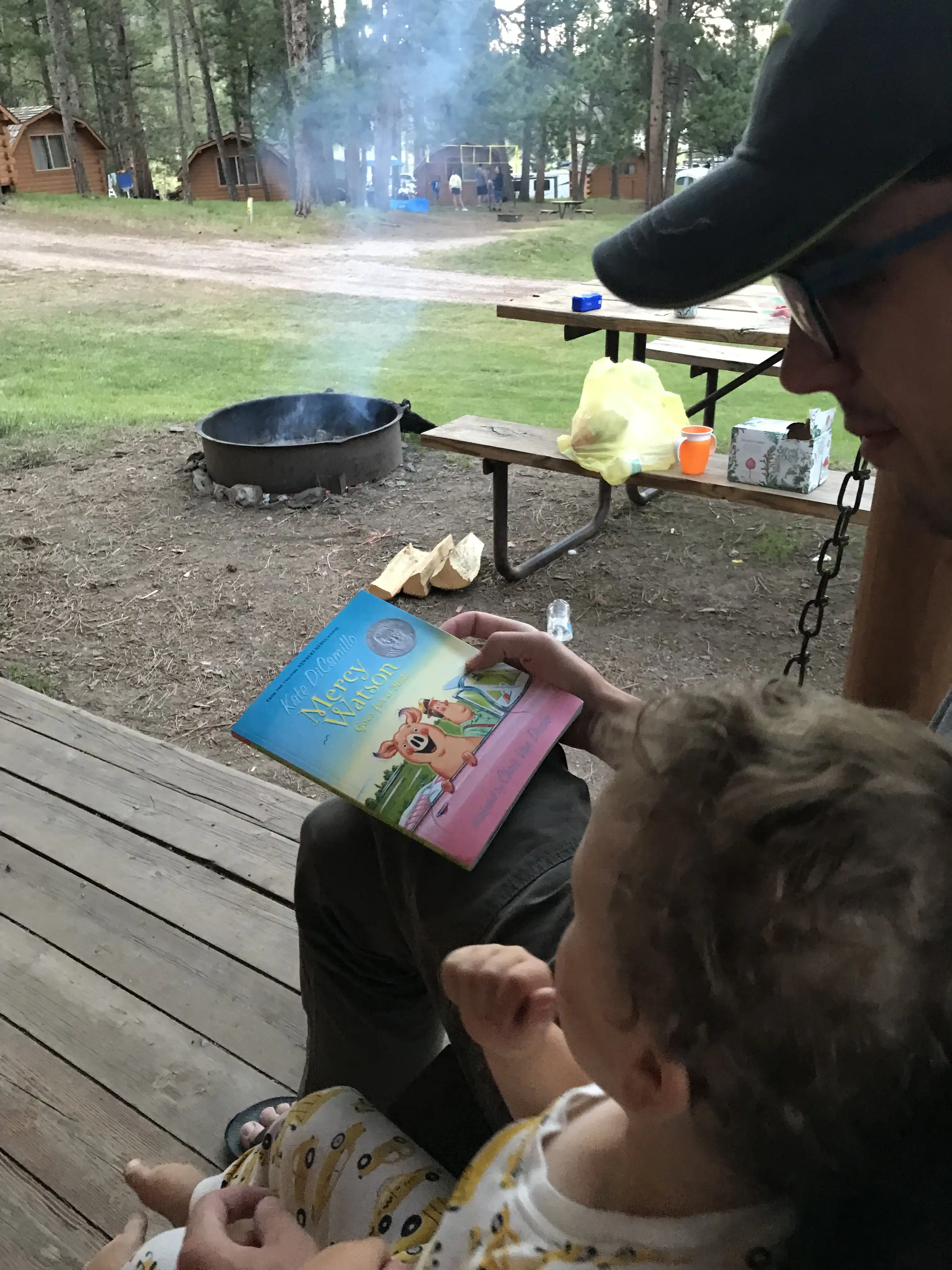 Graham and Alex reading a Mercy book outside our cabin.
