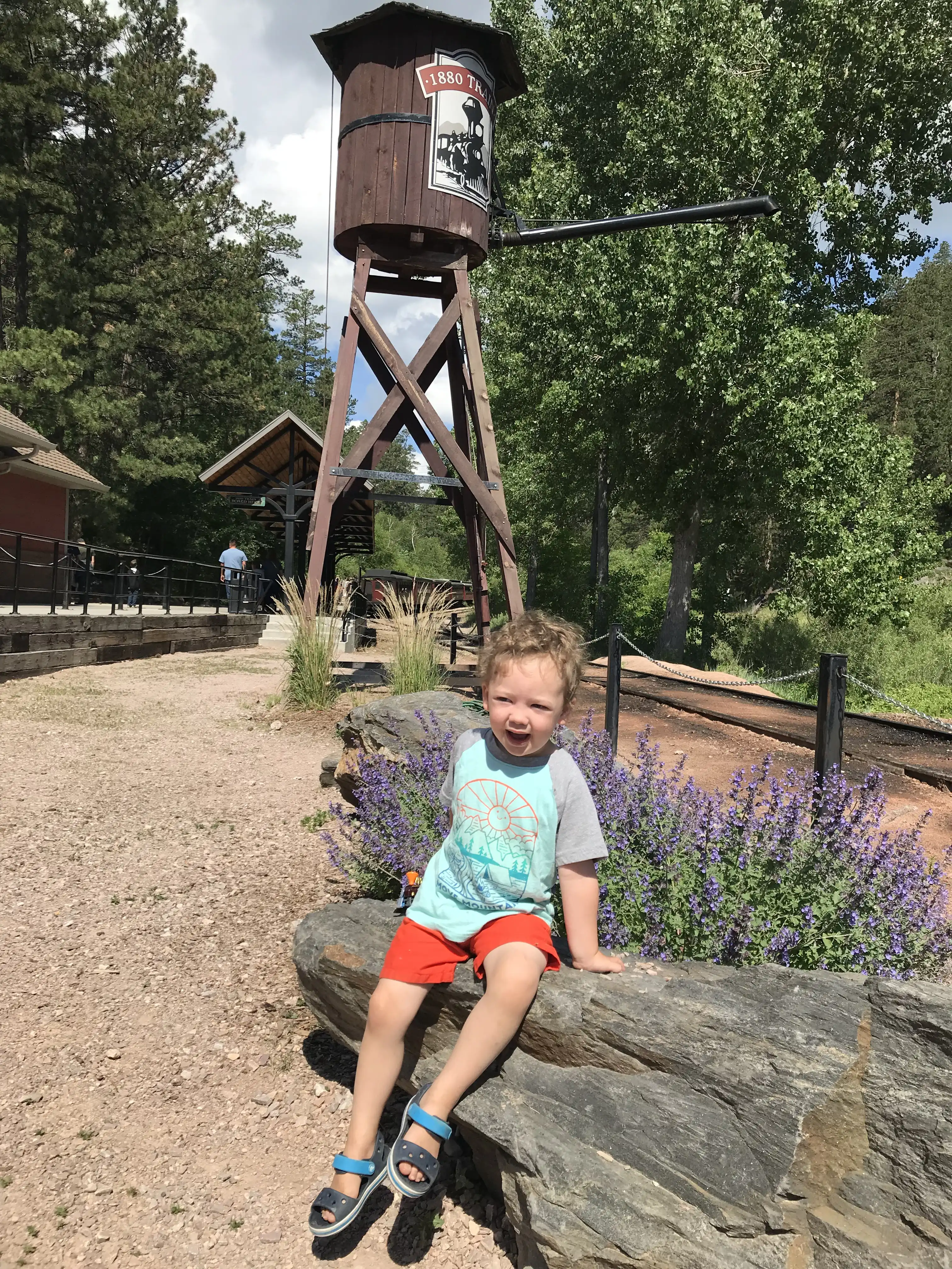 Graham sitting on a rock beside the 1880 train.