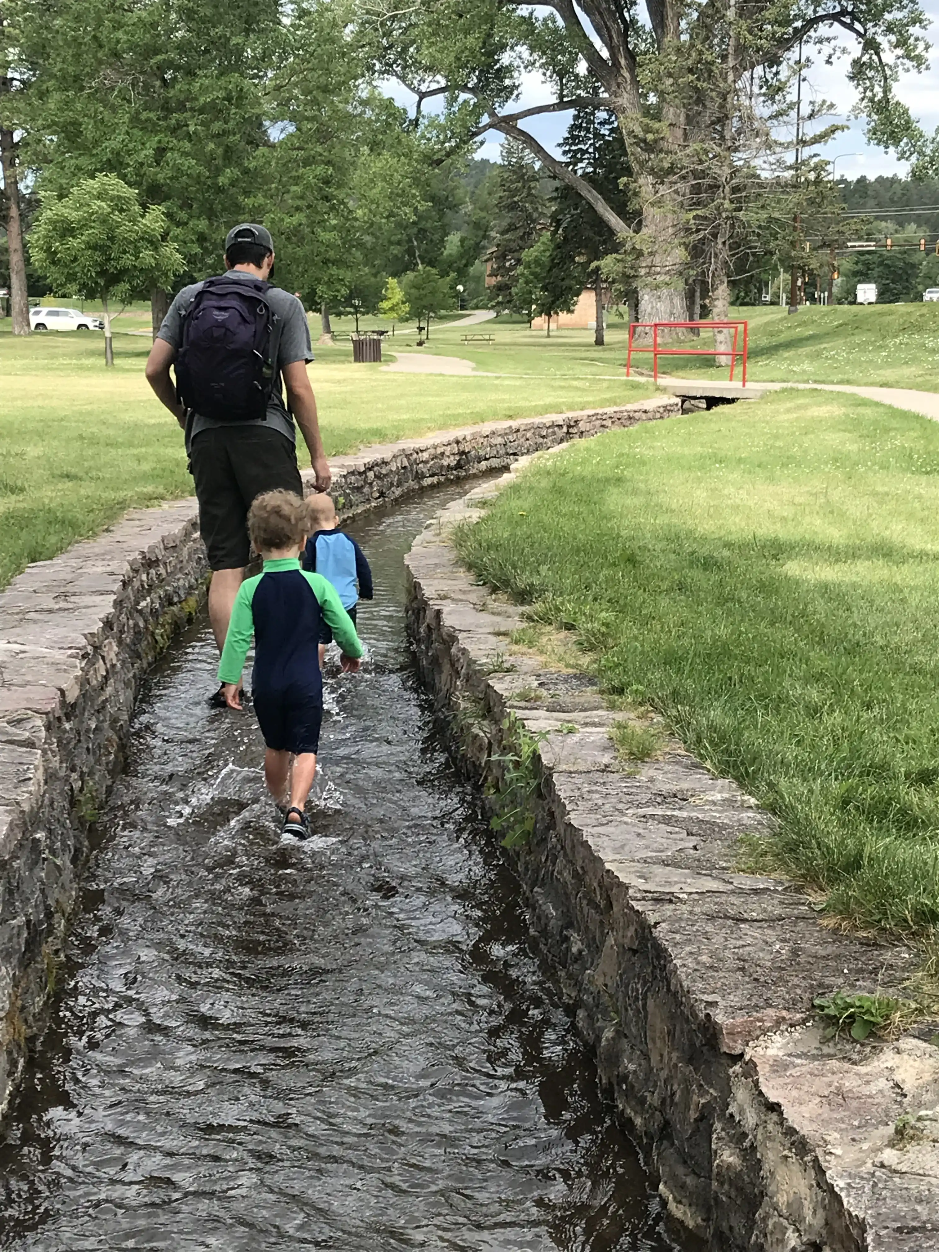 Alex, Graham and Royal wading in the stream at Canyon Lake Park.