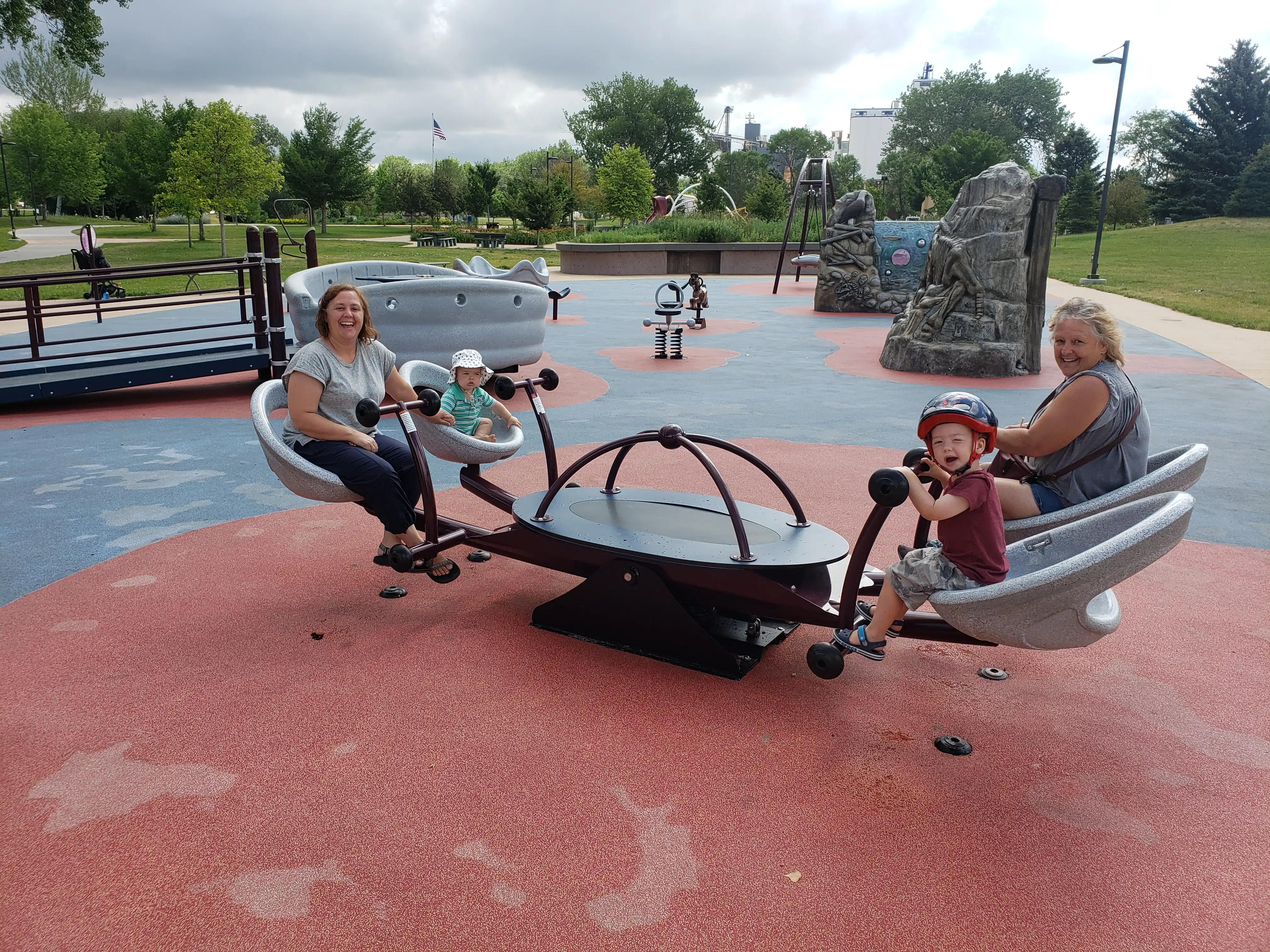 Amie, Jaynne, Graham and Royal at the park on a seesaw.