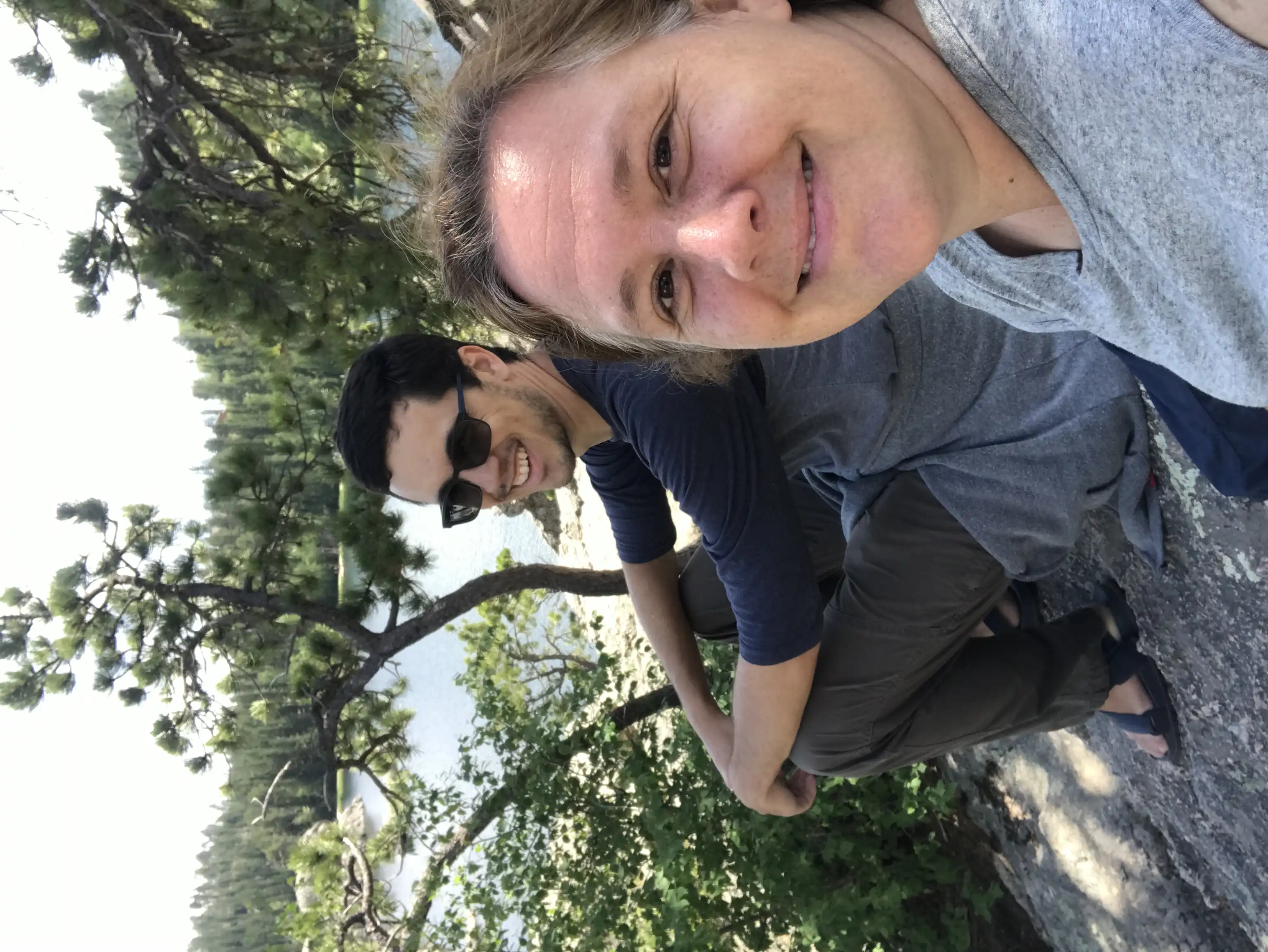 Amie and Alex on a rock with a view of Sylvan Lake.