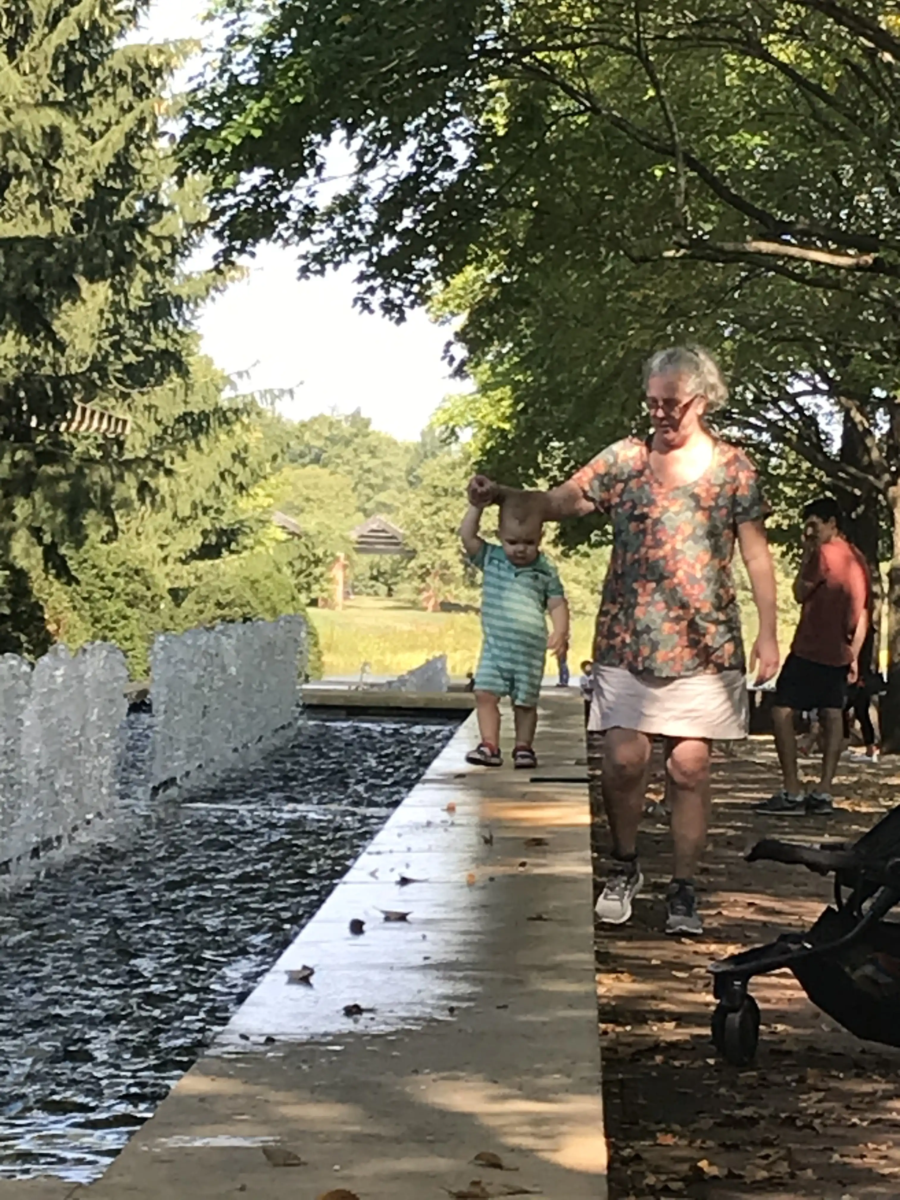 Mema Walks Royal Near a Fountain