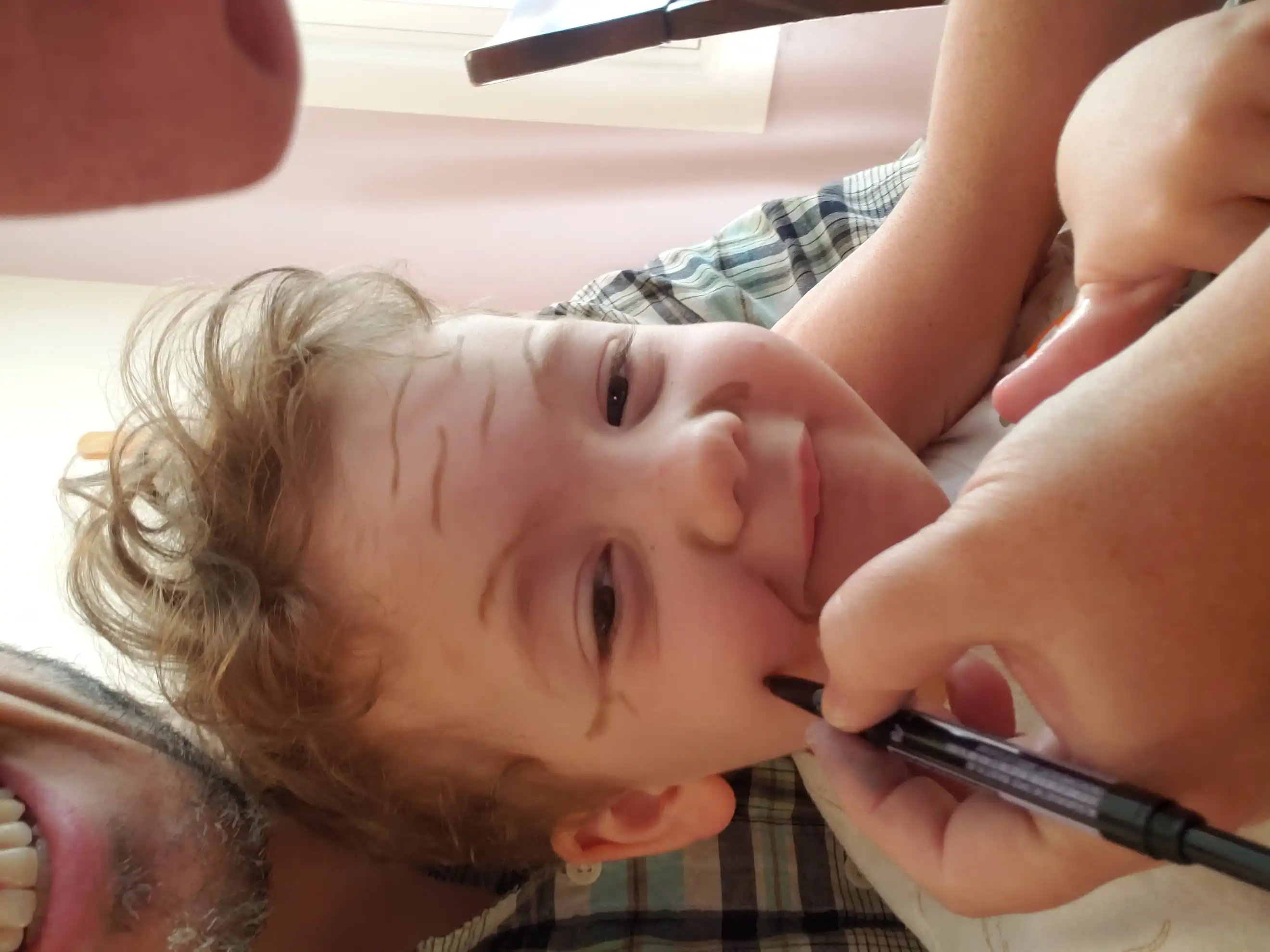 Amie painting Graham's face with old-age lines.