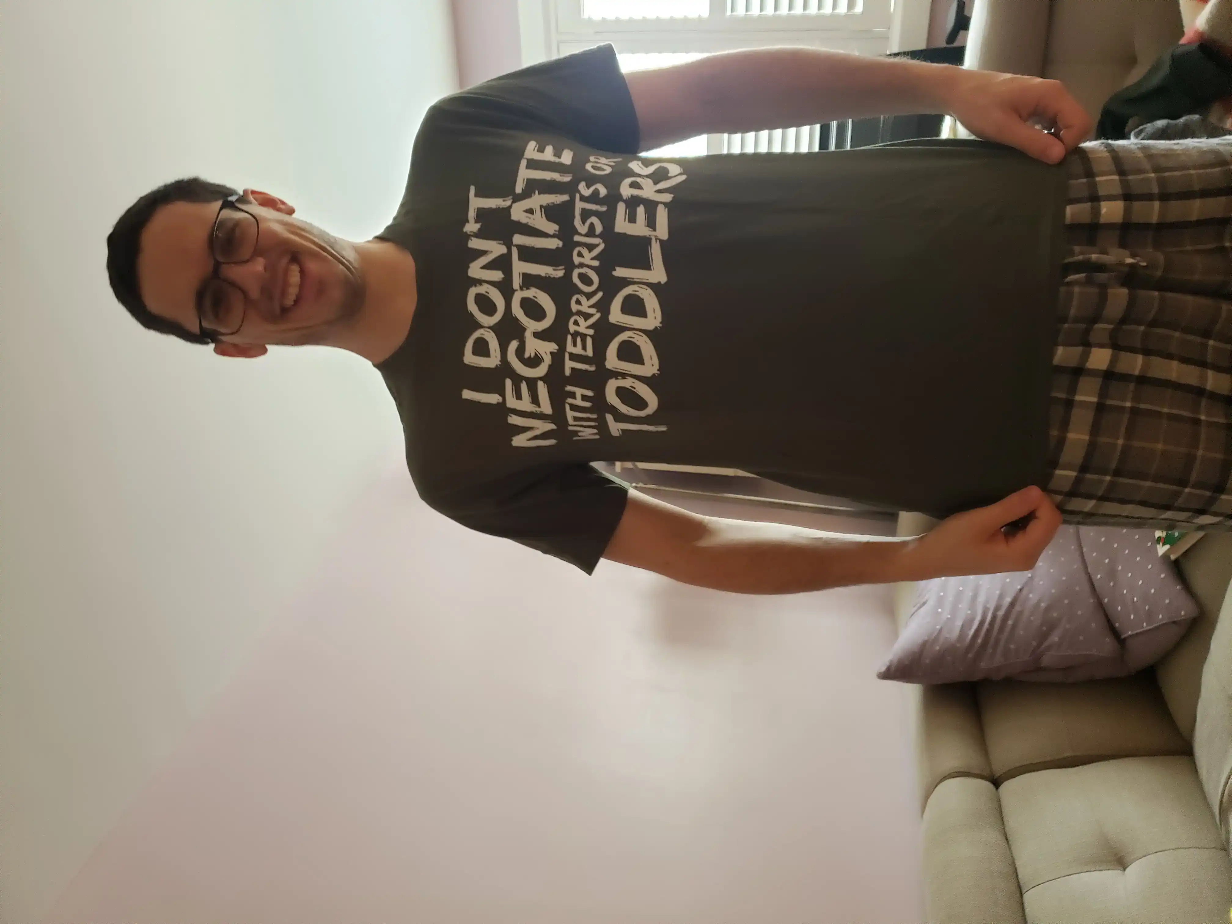 Alex wearing a shirt that reads, 'I don't negotiate with terrorists or toddlers.'