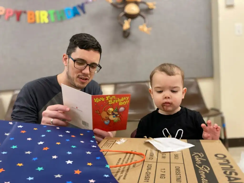 Alex reading a birthday card to Royal.