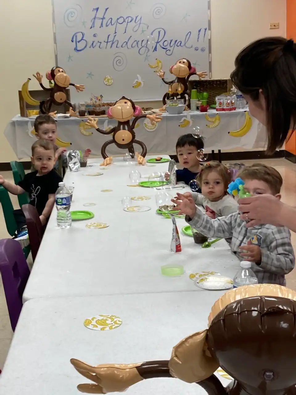 Royal, Graham, Nikki, Charlotte, and Jotham seated at the birthday table.