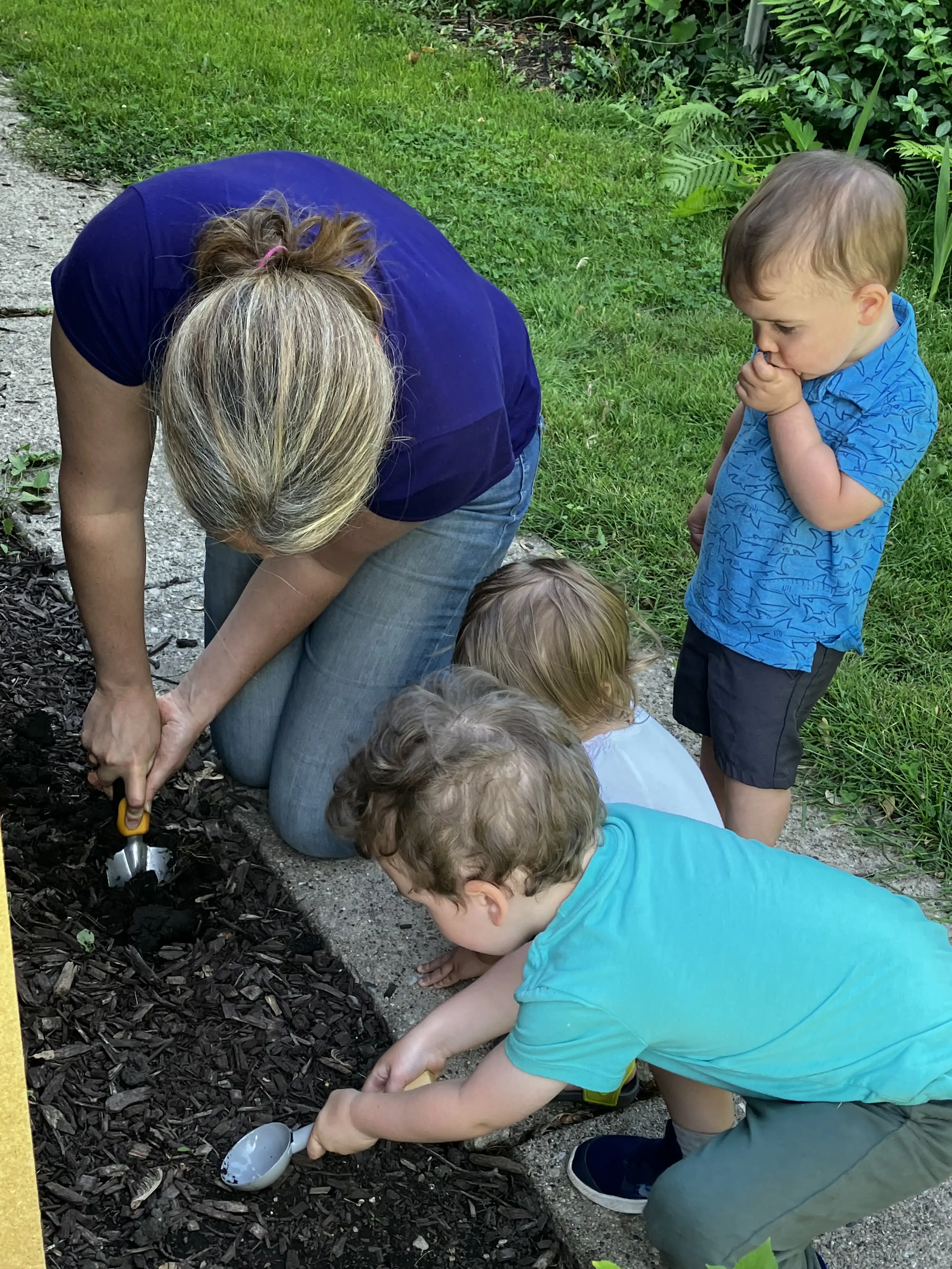 Sharon, Graham, Charlotte and Royal digging in the flower garden.