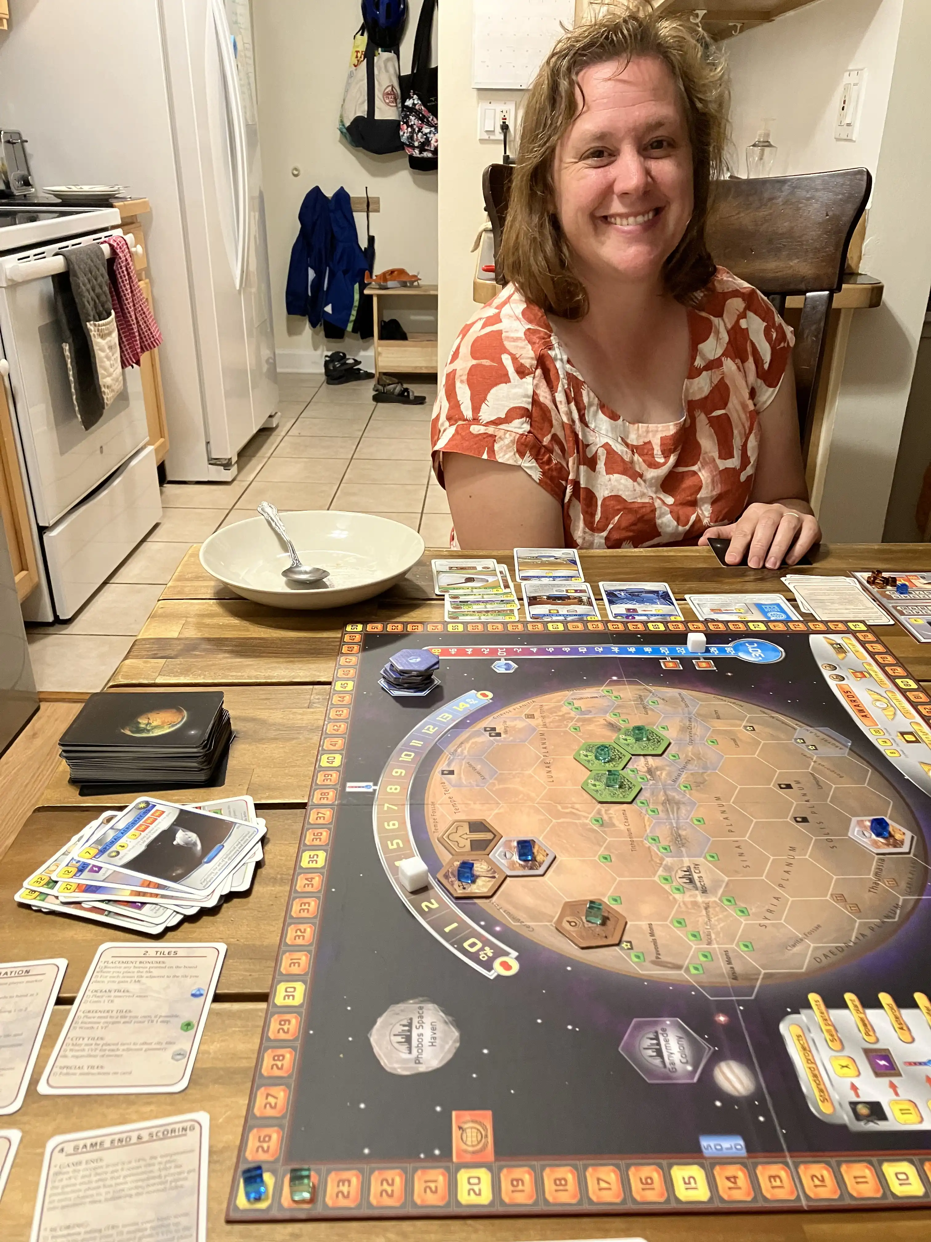 Amie smiling over a game of Terraforming Mars.