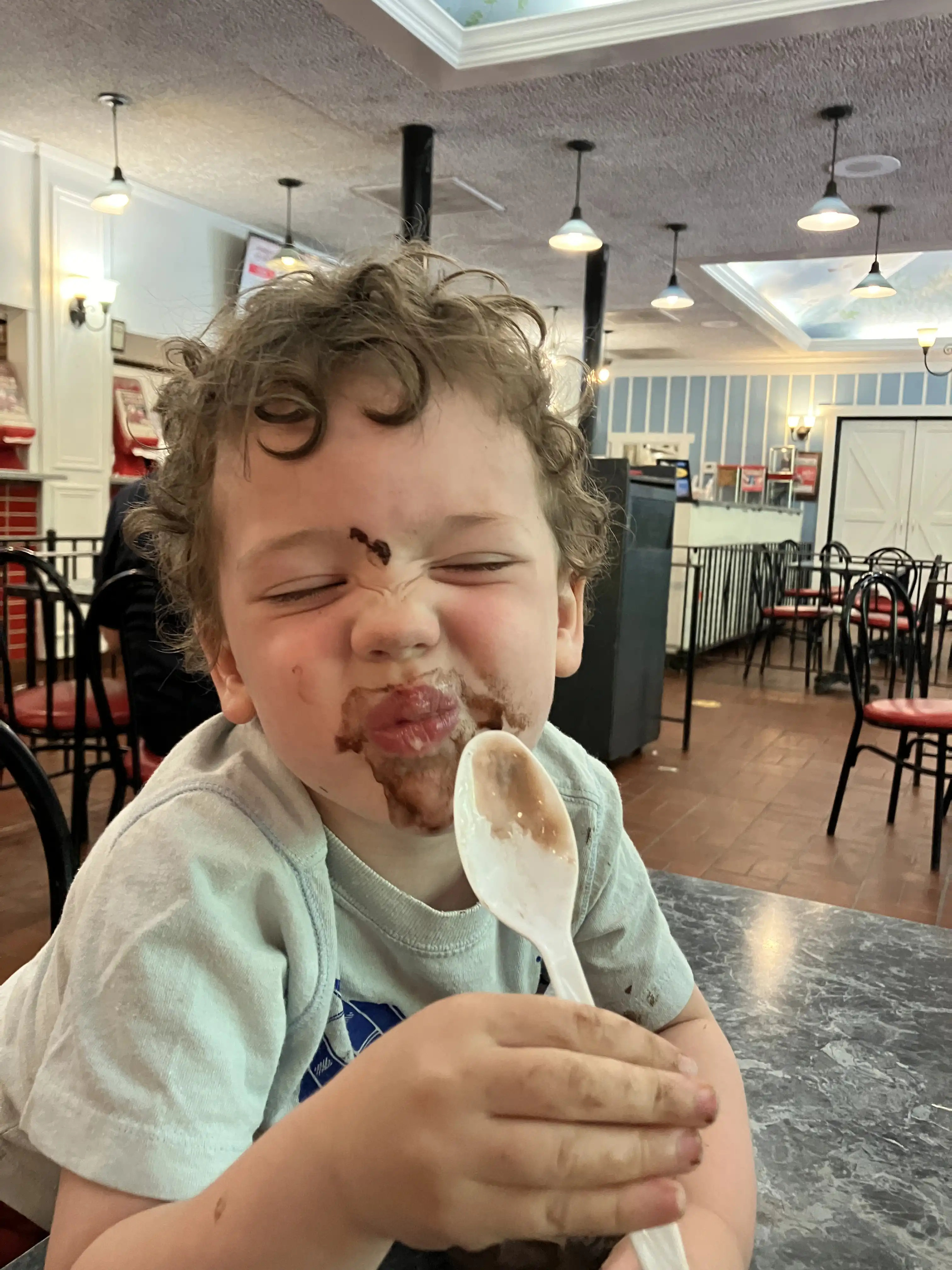 Graham at Homer's with face covered in chocolate ice cream.
