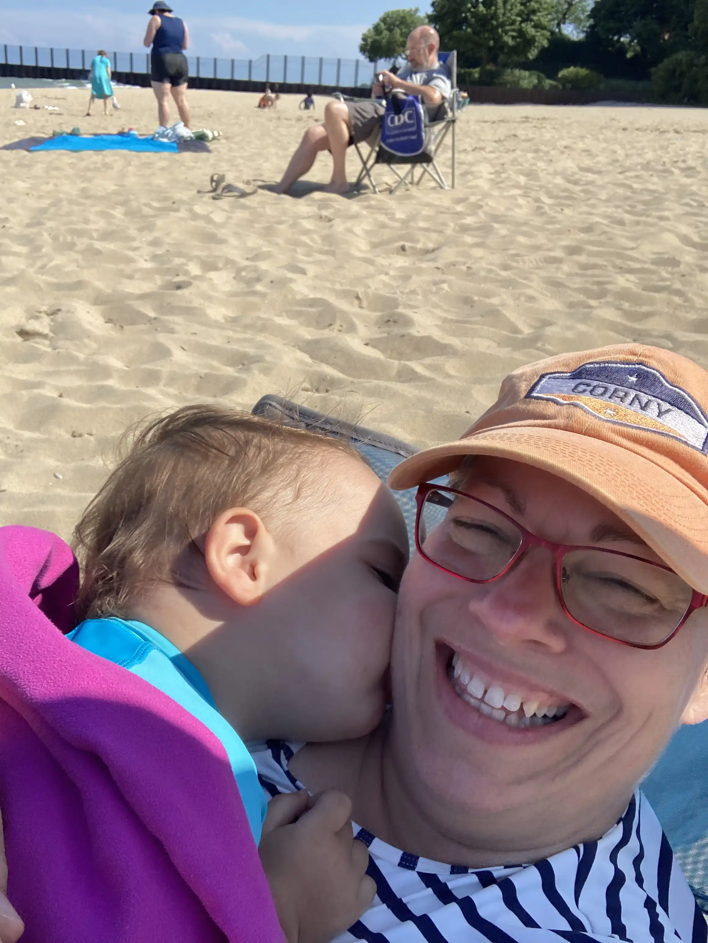 Royal kissing Kati's cheek at the beach.