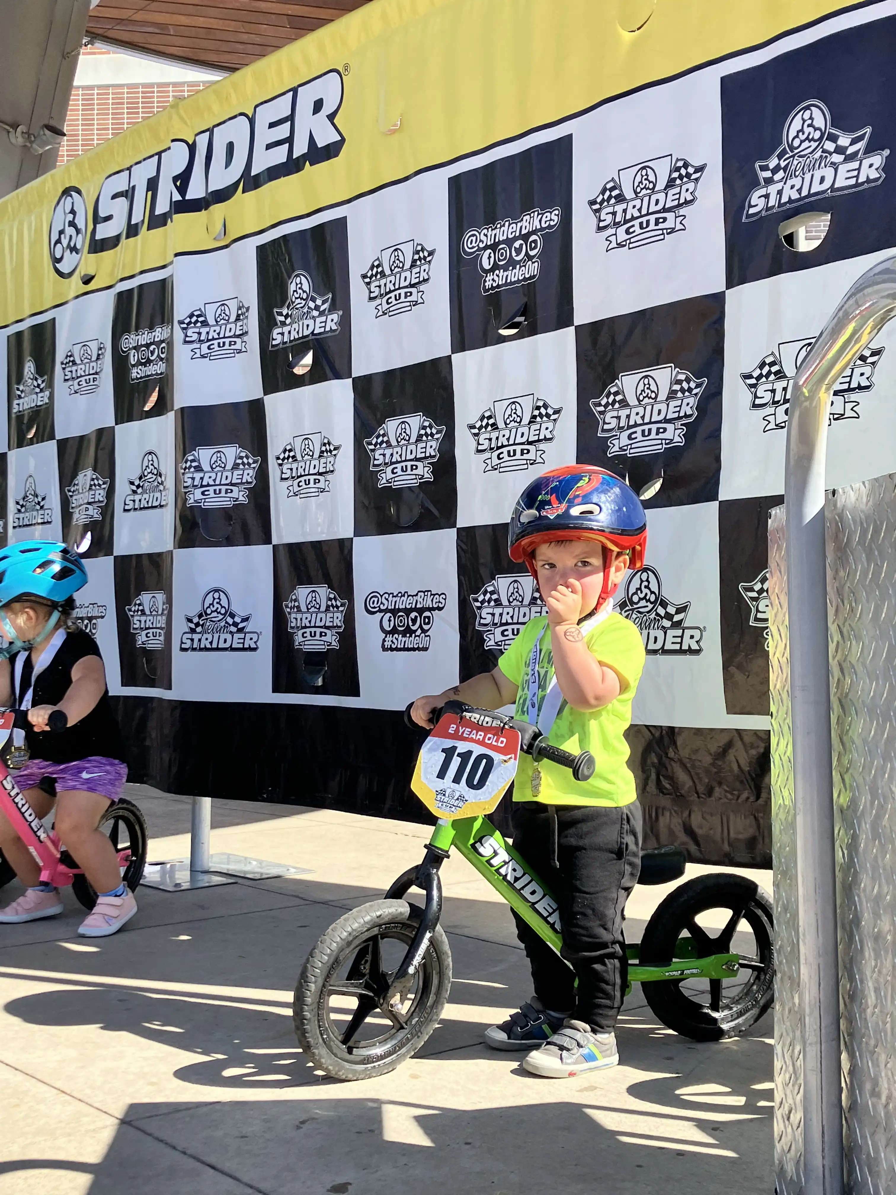Royal on his Strider bike at the award ceremony.