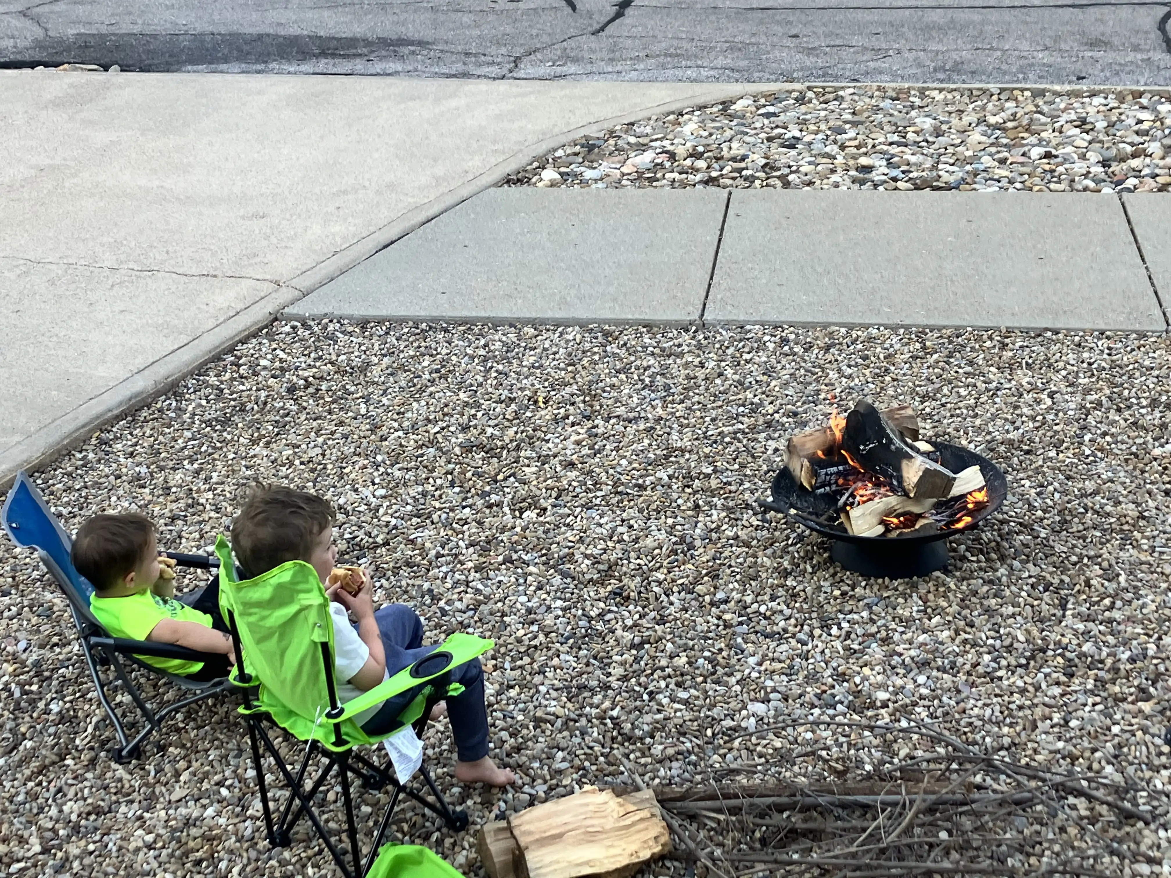 Graham and Royal sitting in chairs by the campfire.