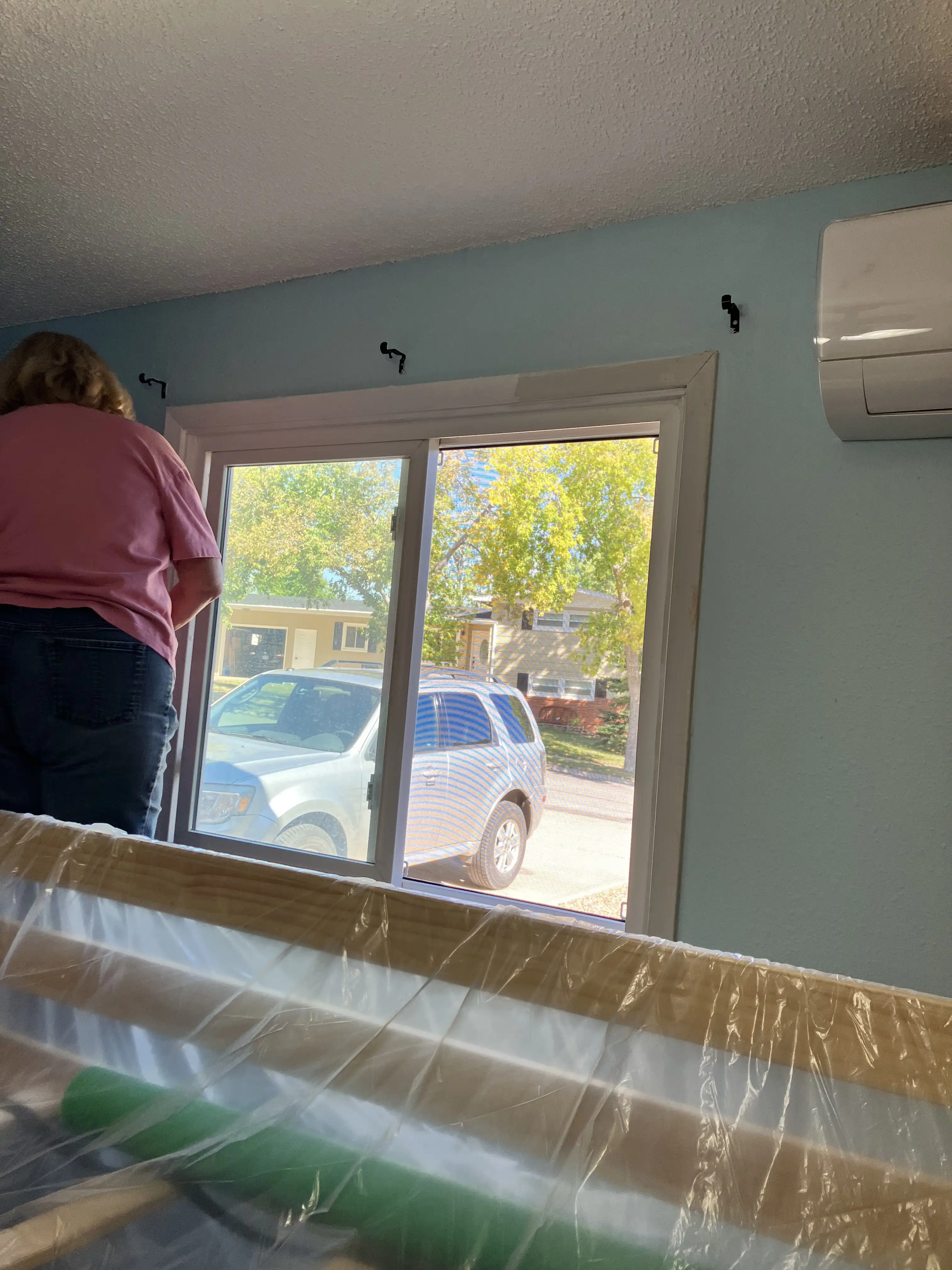 Deb painting the window frame.