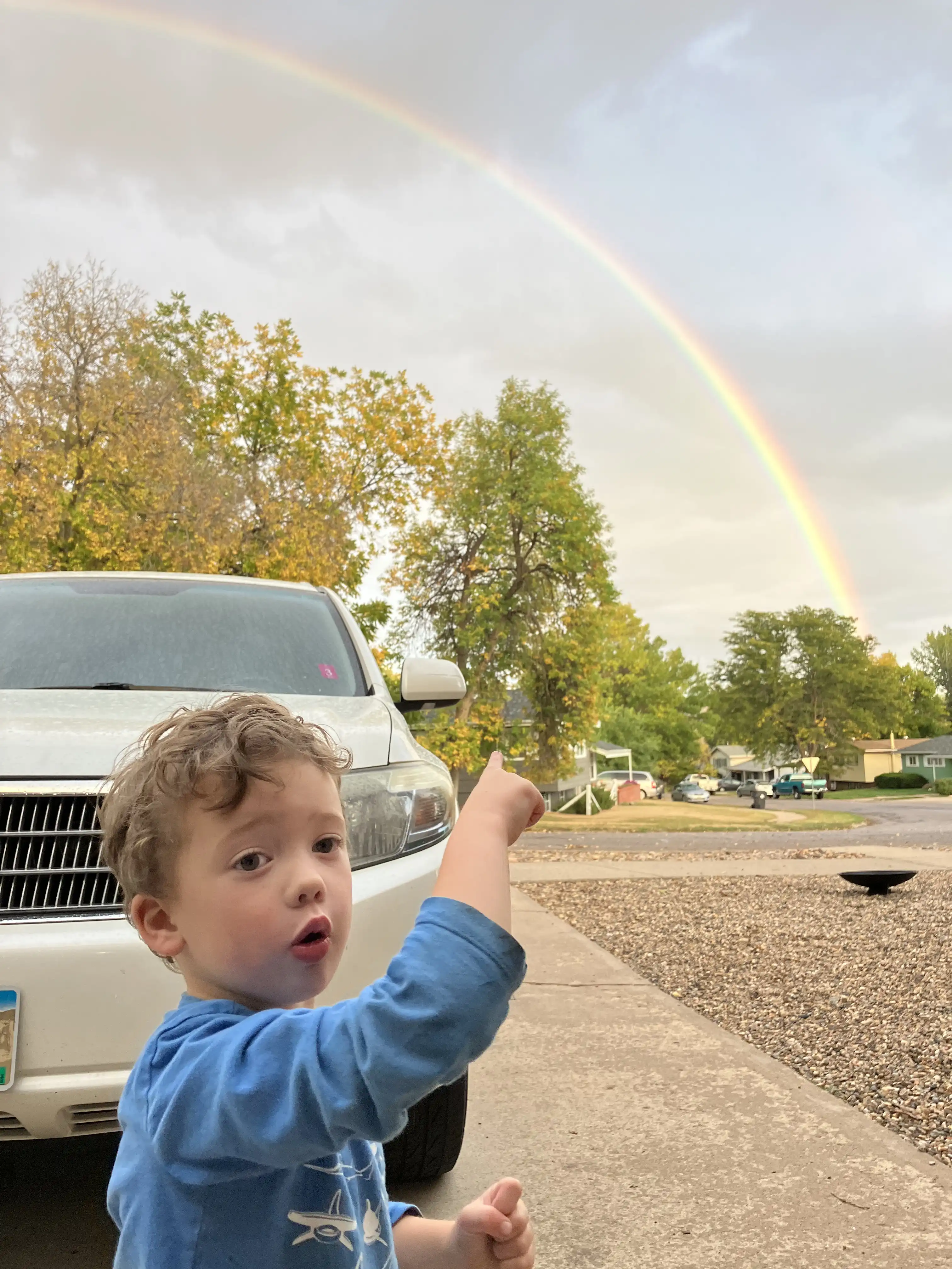 Graham pointing at a double rainbow.