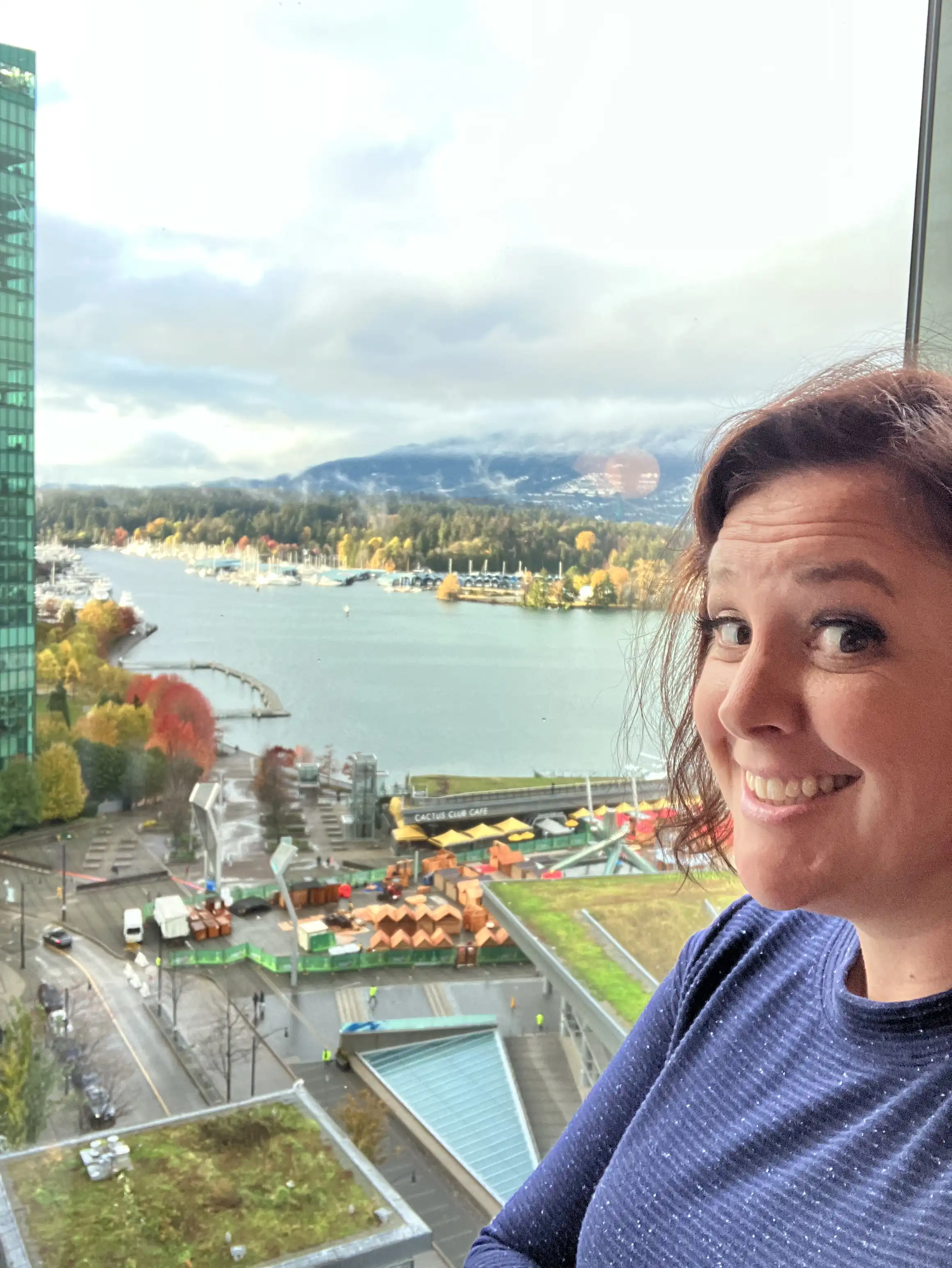 Amie standing near a window overlooking Vancouver bay.