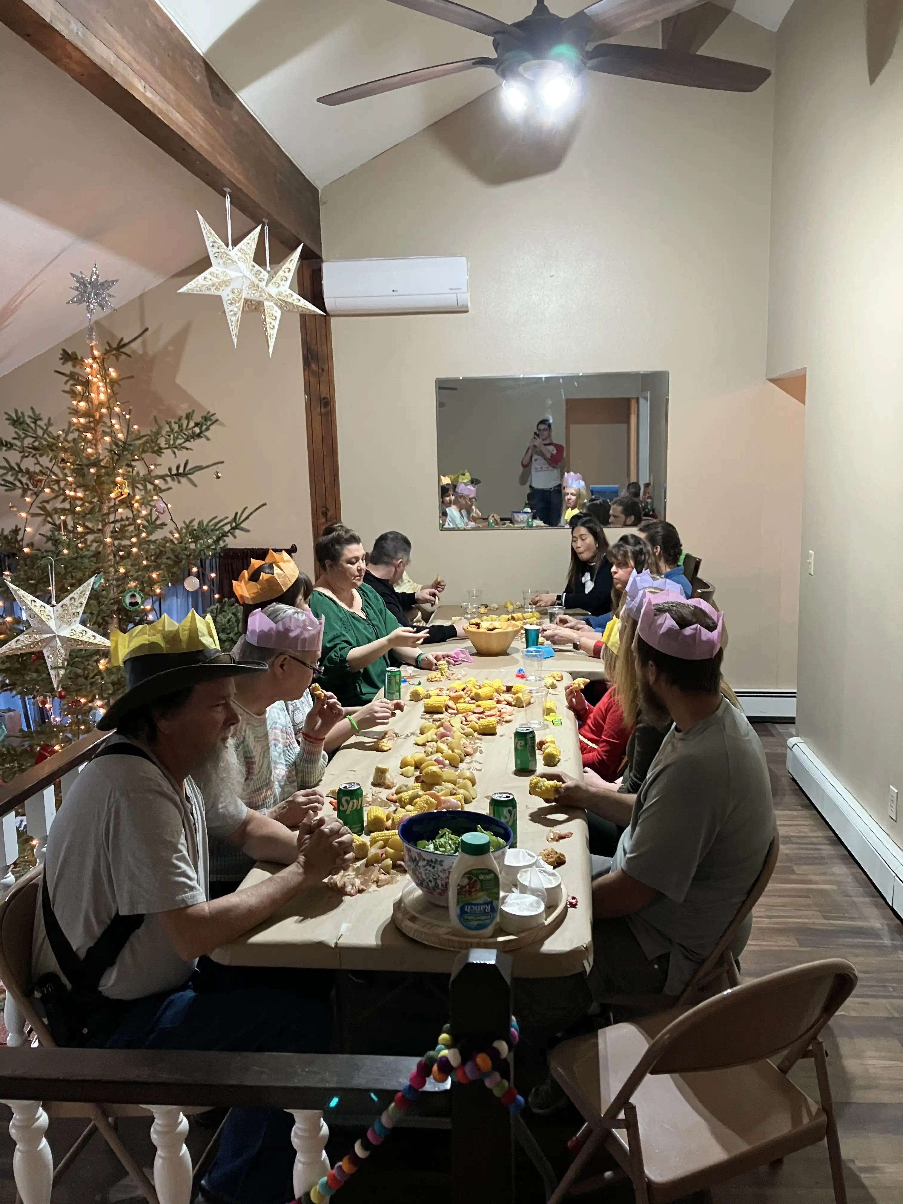 Everyone eating Christmas dinner around the table.