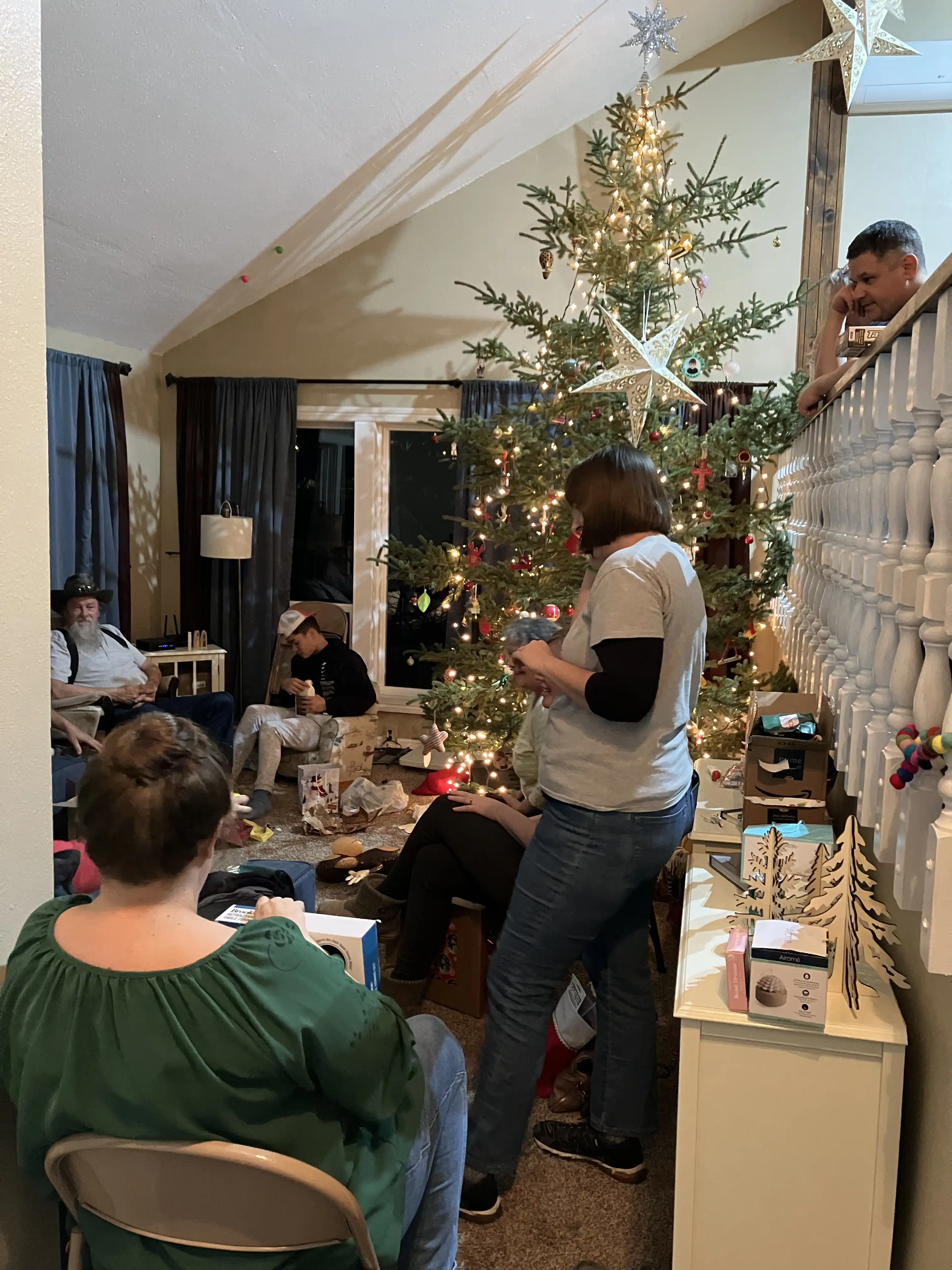 Everyone in the living room opening white elephant gifts.