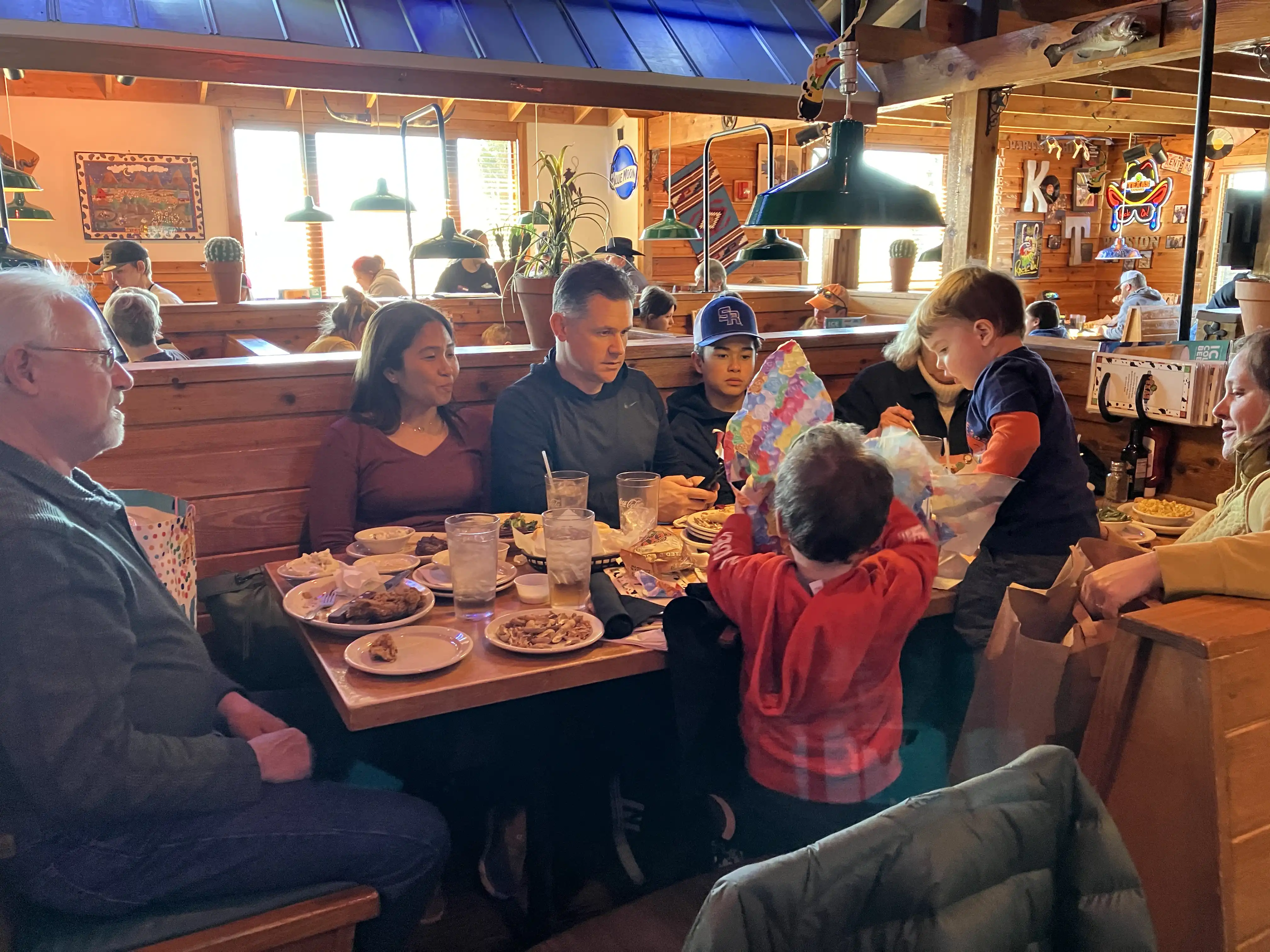 Royal opens gifts at Texas Roadhouse for his birthday lunch celebration.