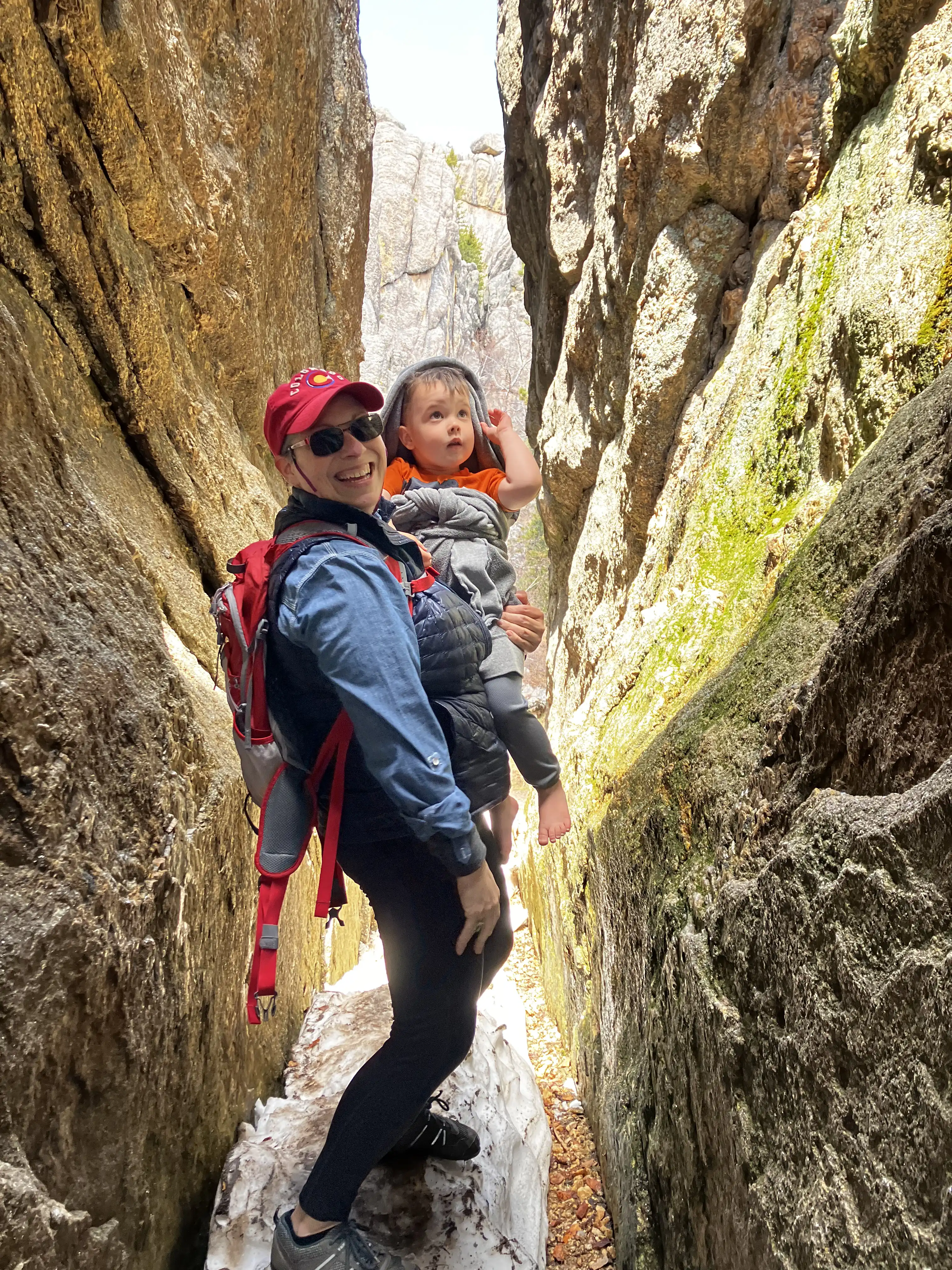 Kati holding Royal on a hiking trail in a crevasse.