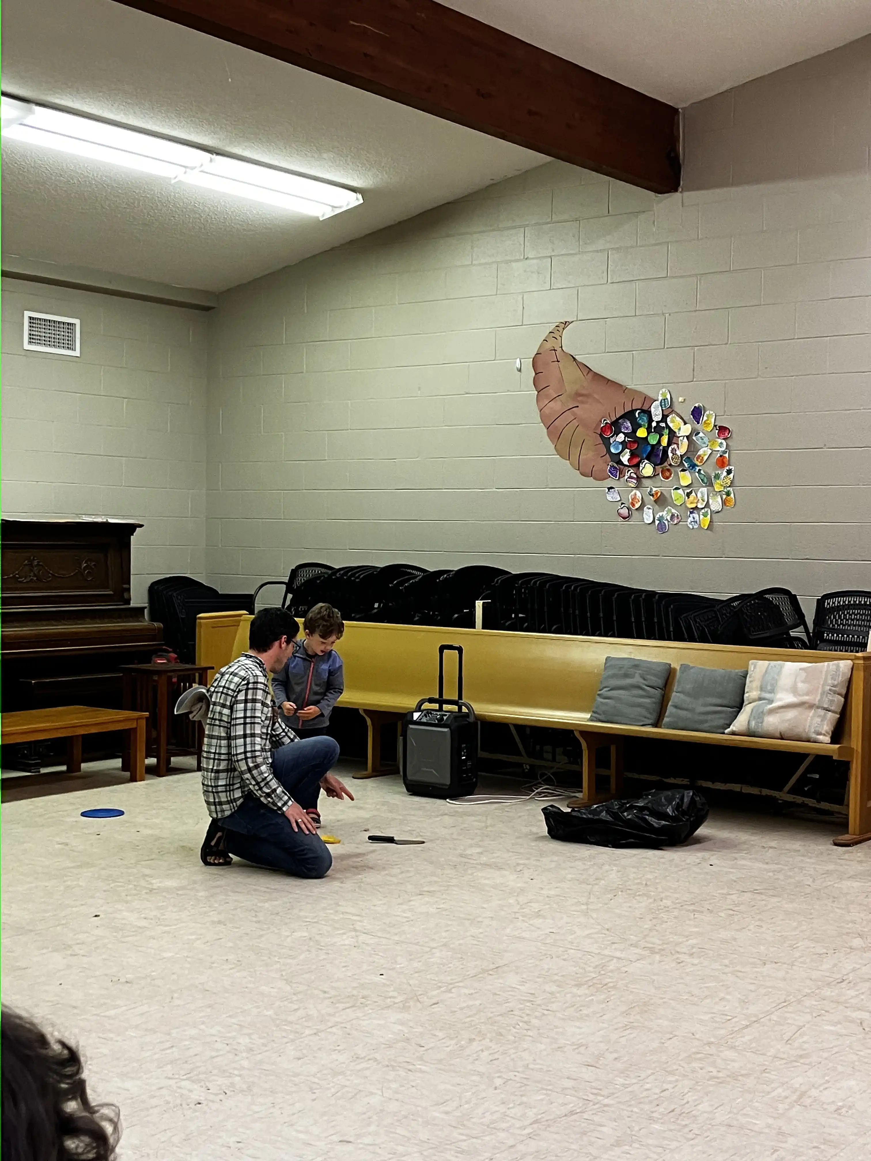 Graham and Alex conducting a skit inside the camp lodge.