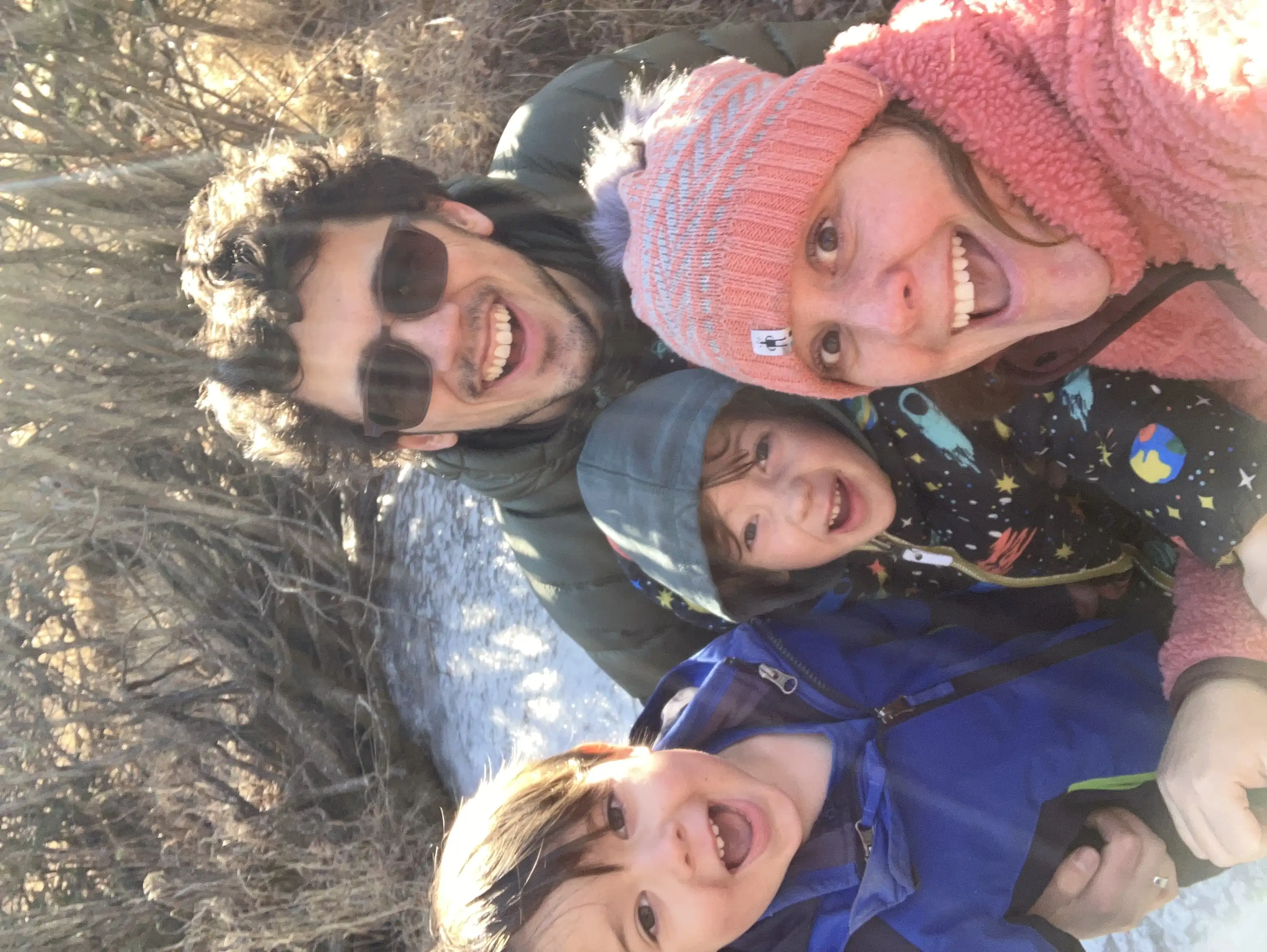 Our family posing for a photo near the frozen stream that the boys played at while I retrieved our Christmas tree