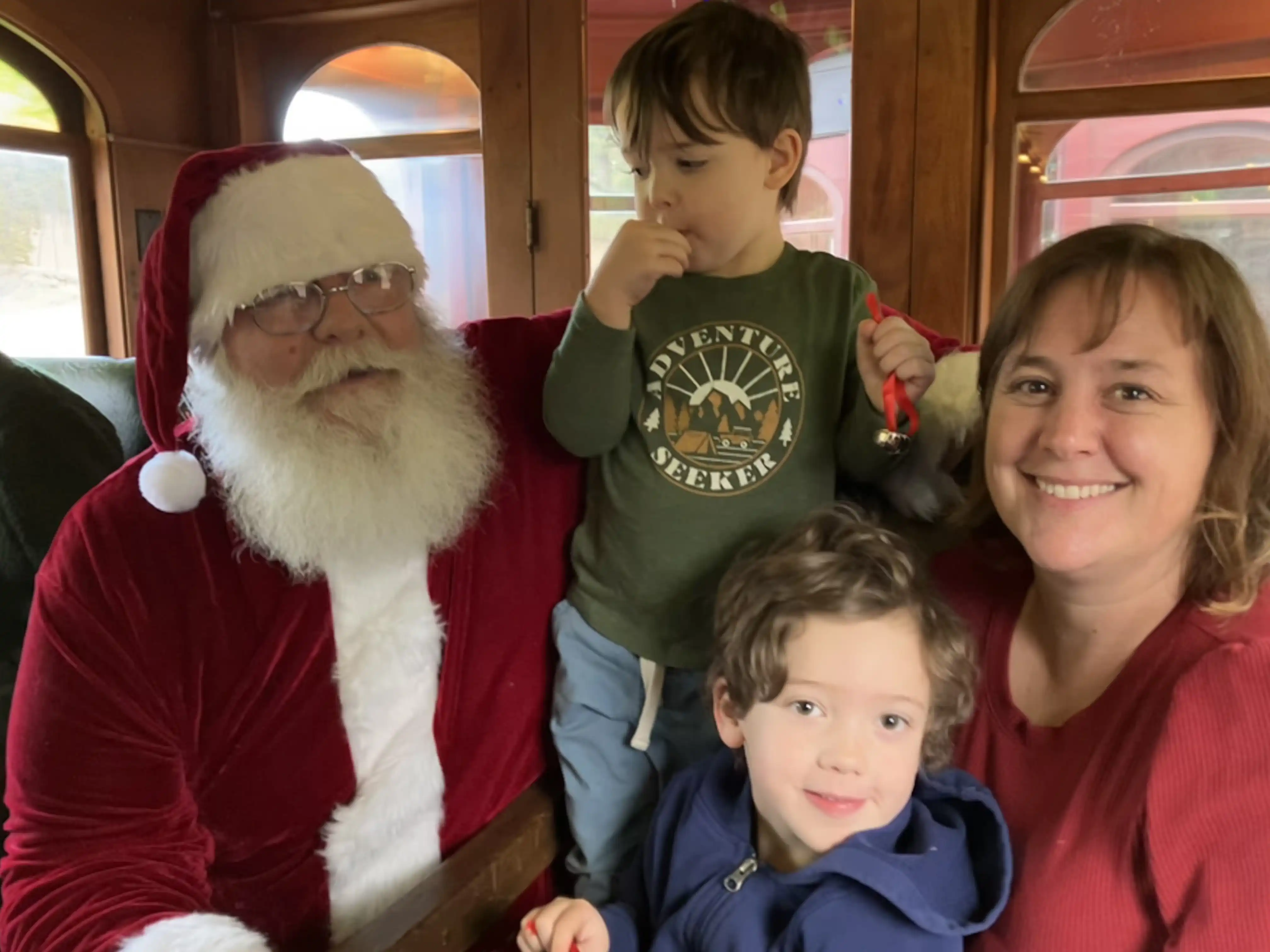 Graham, Royal and Amie posing with Santa Claus on the 1880 Christmas train
