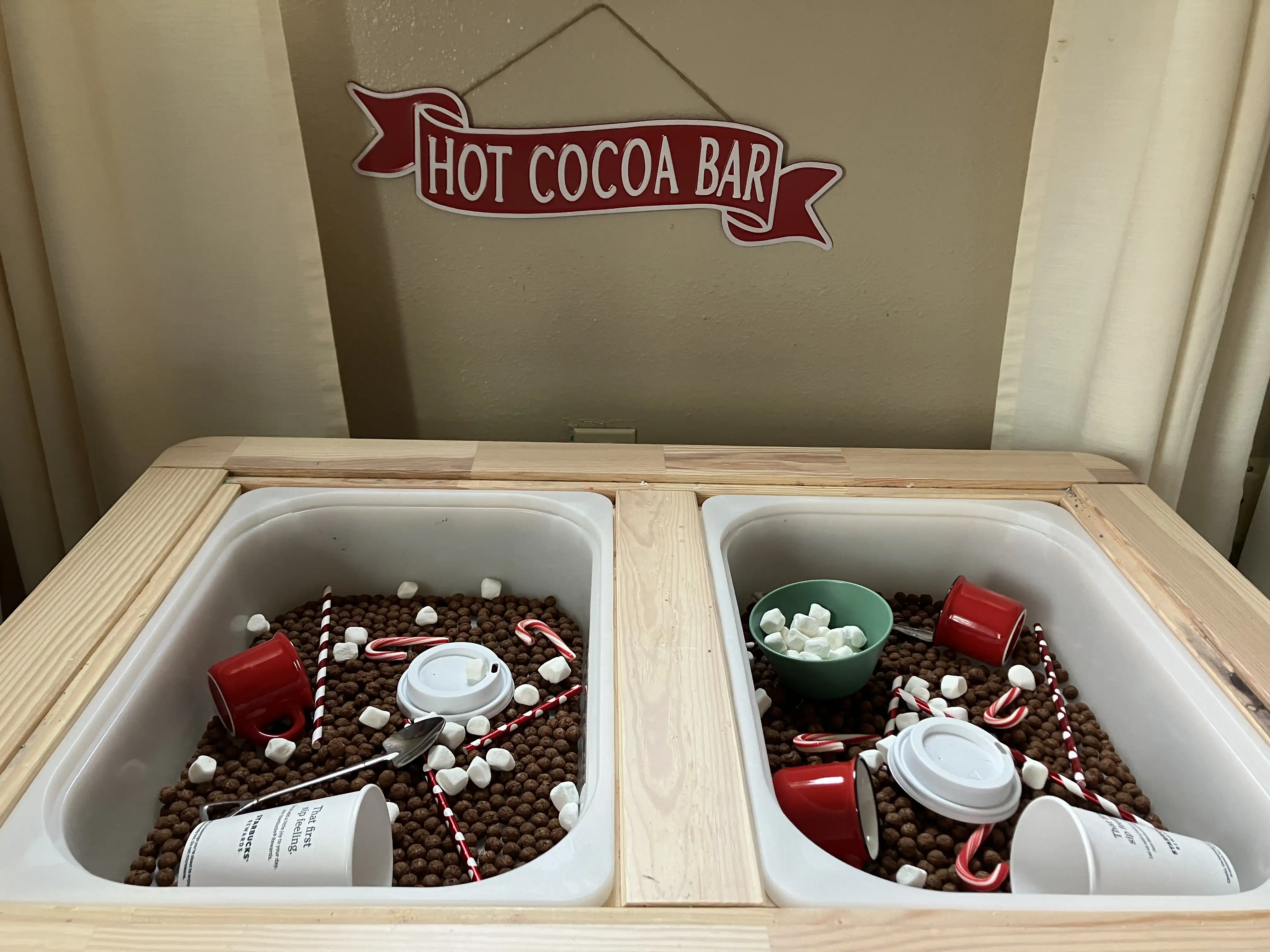 Graham and Royal's sensory bins filled with cocoa puffs, marshmallows, straws, and candycanes