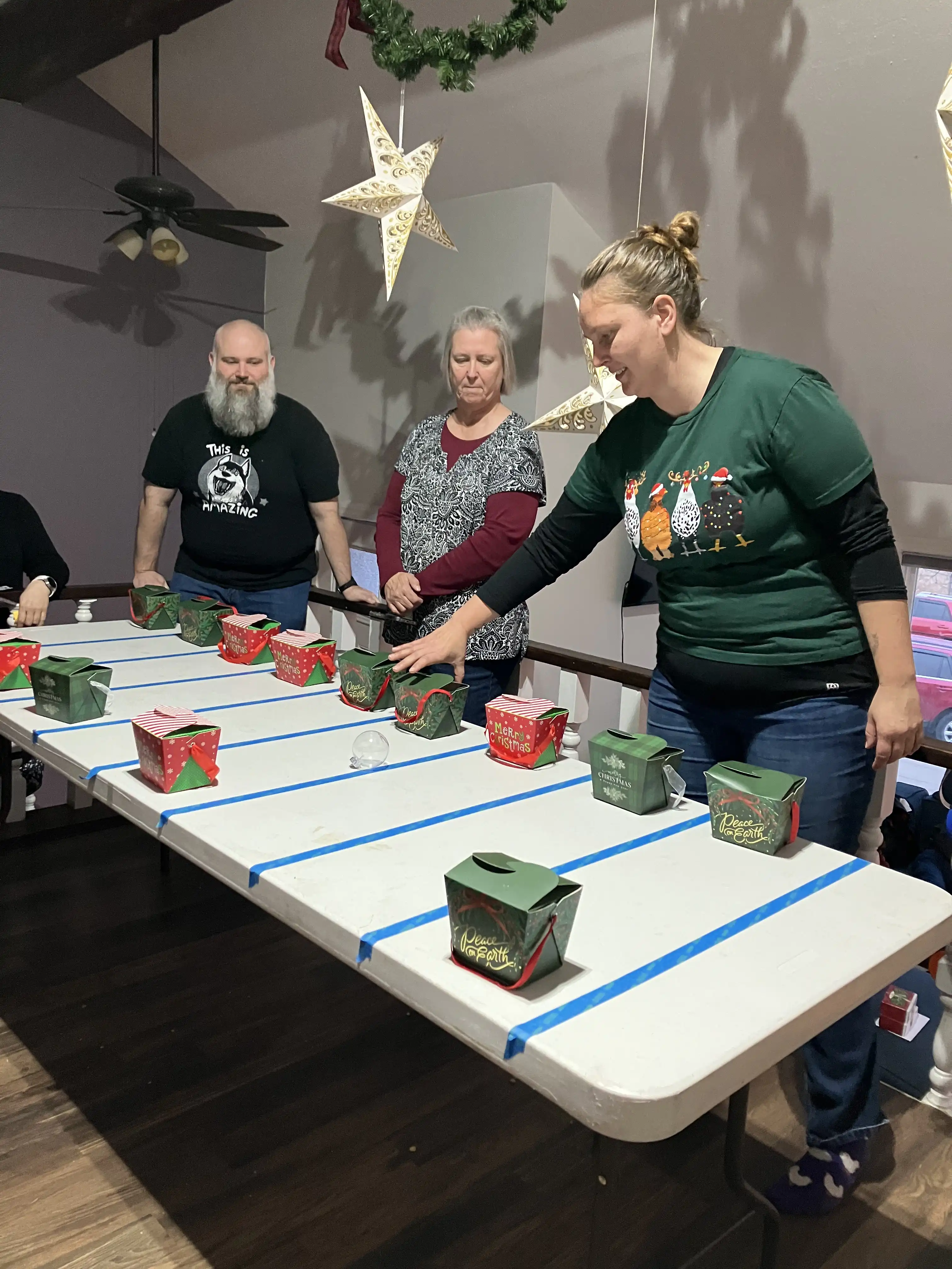 Andrew, Barb, and Elizabeth playing the ornament game