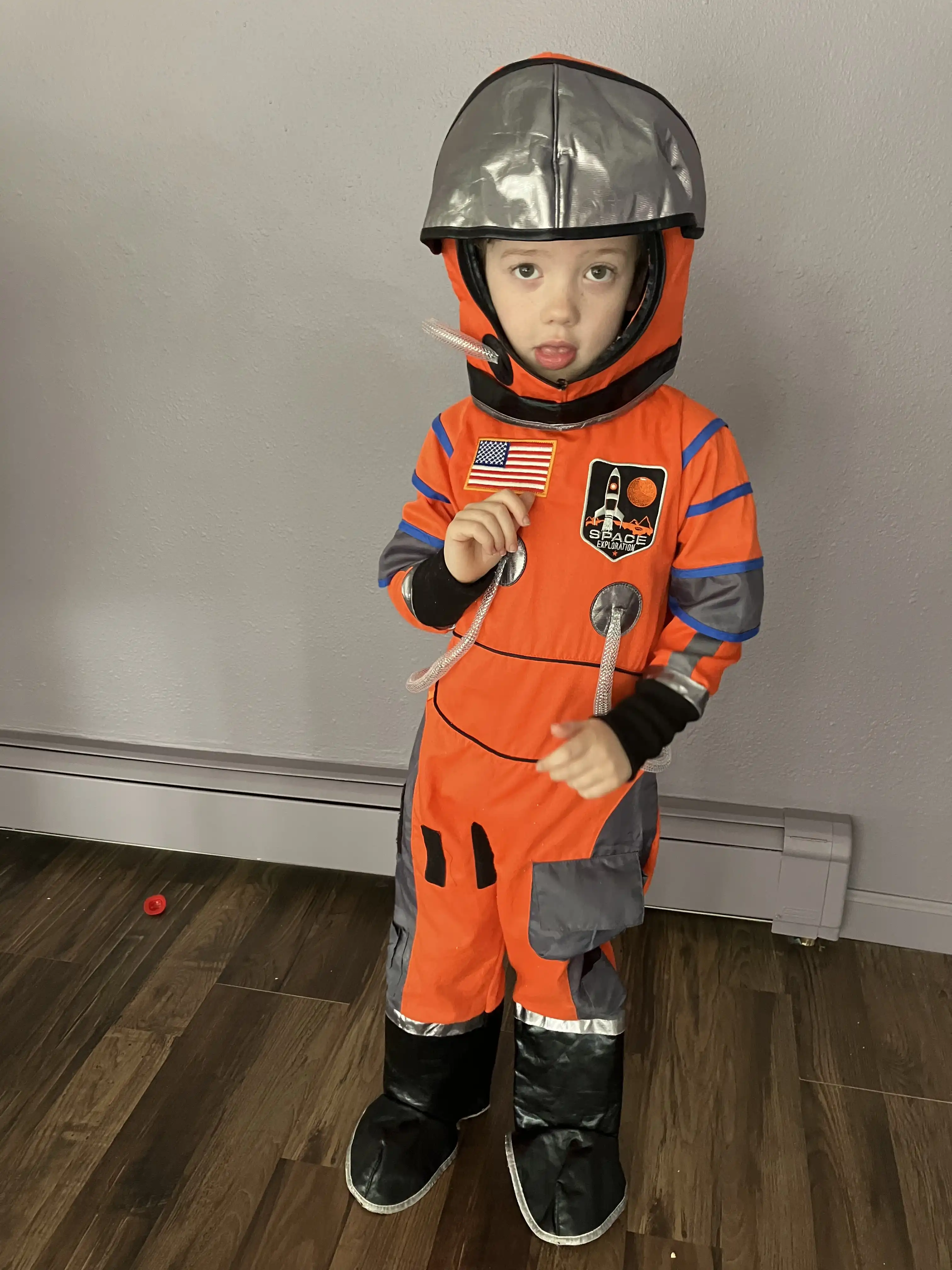 Graham in an orange astronaut jumpsuit.