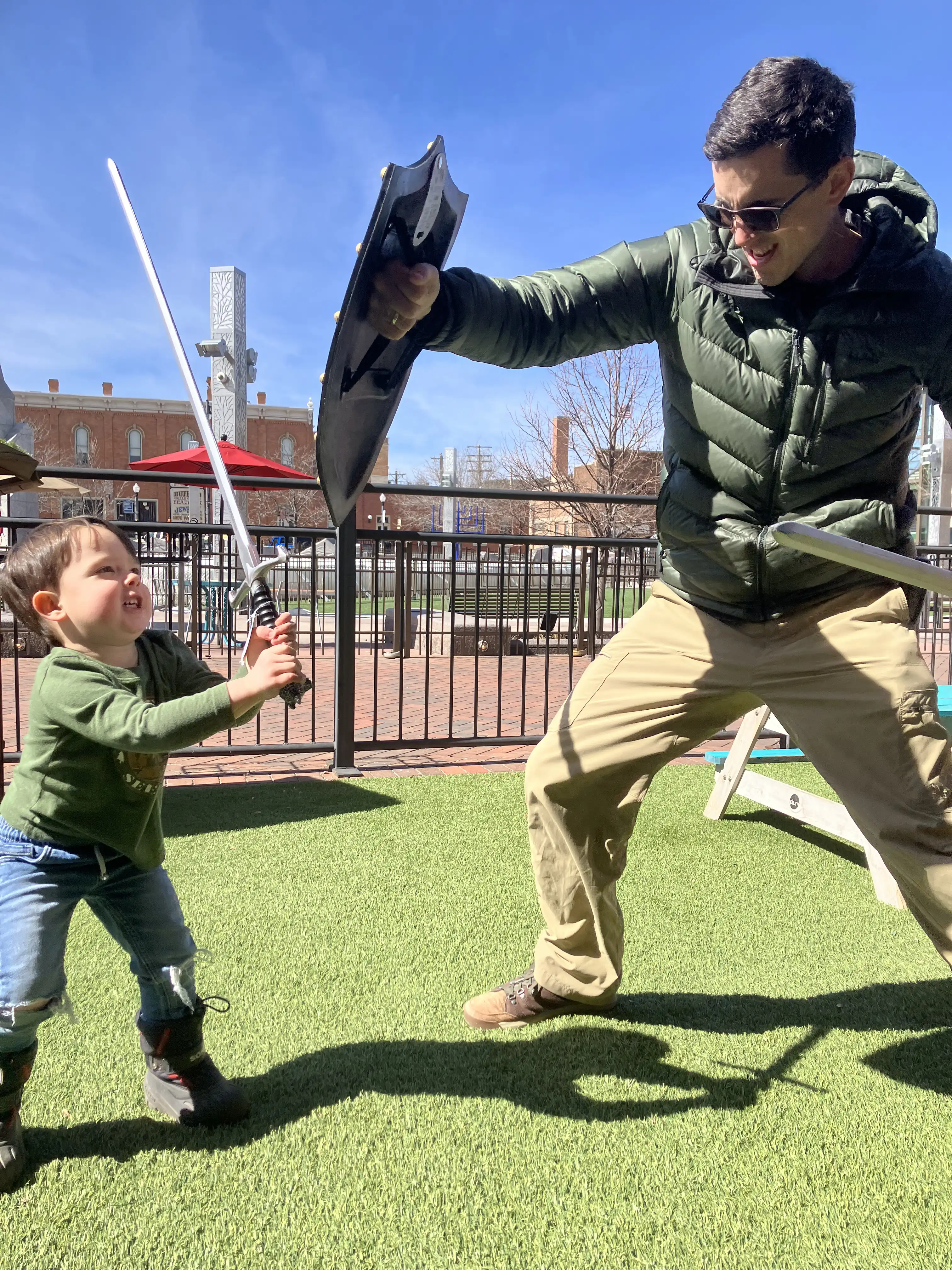 Alex and Royal engaged in a swordfight. Royal looks like David against Alex the Goliath.