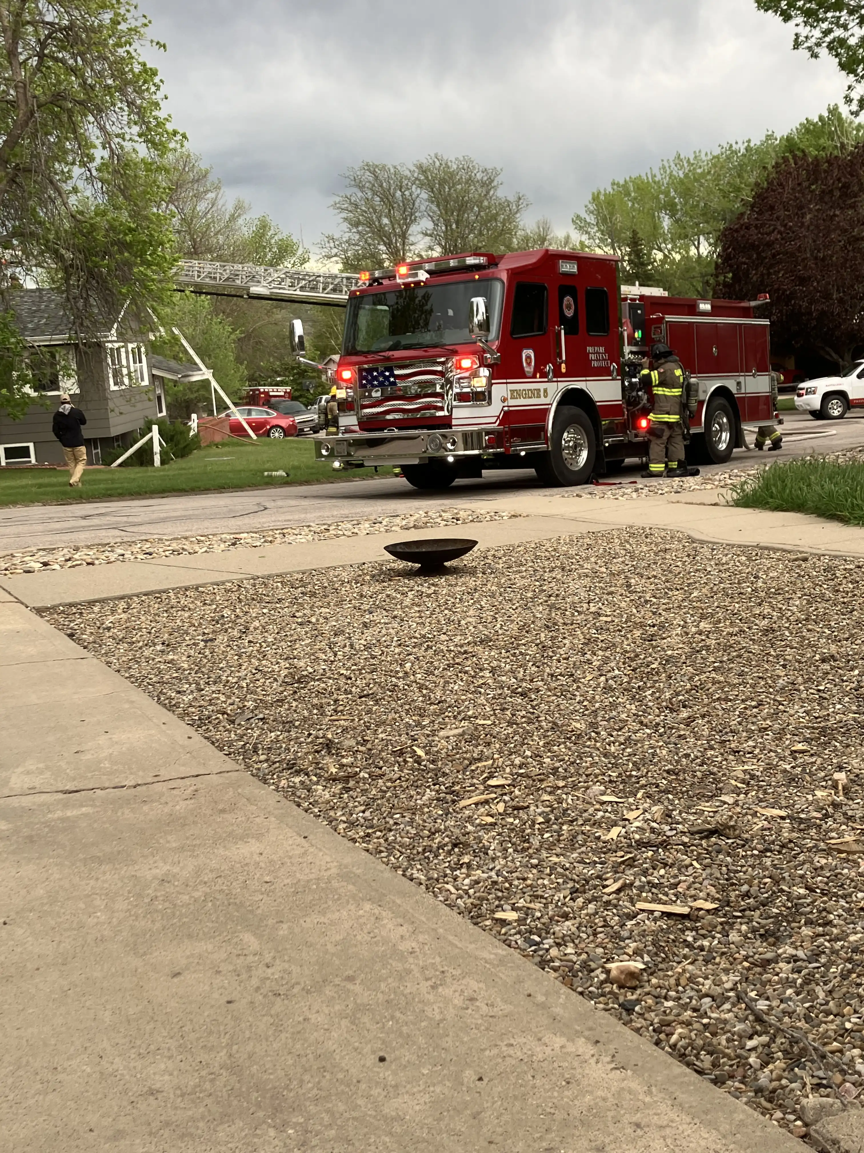 The fire trucks outside our house, putting out a fire at the neighbor's house across the street