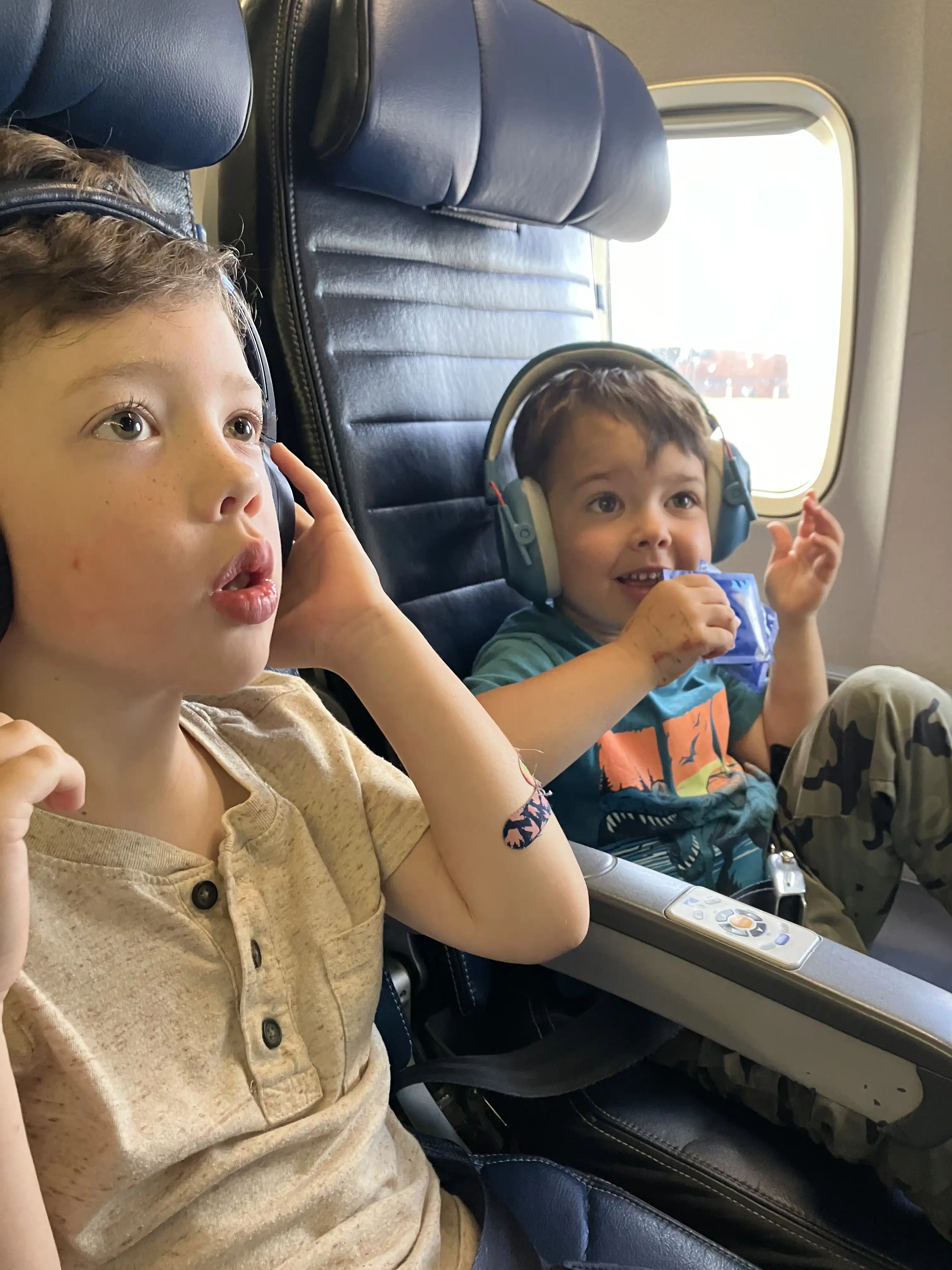 Graham and Royal with thrilled faces in the airplane.