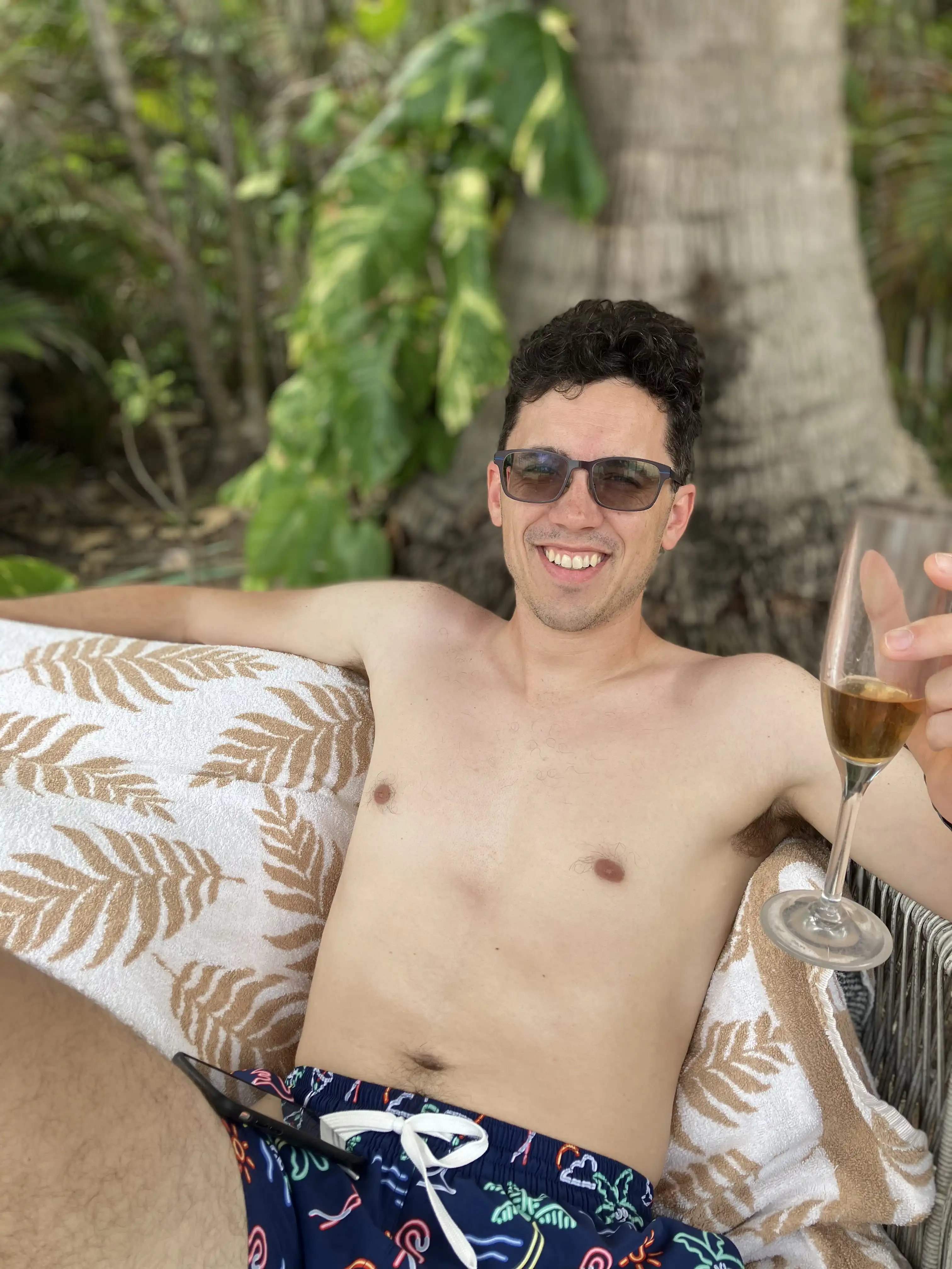 Alex lounging at the pool with a whiskey neat.