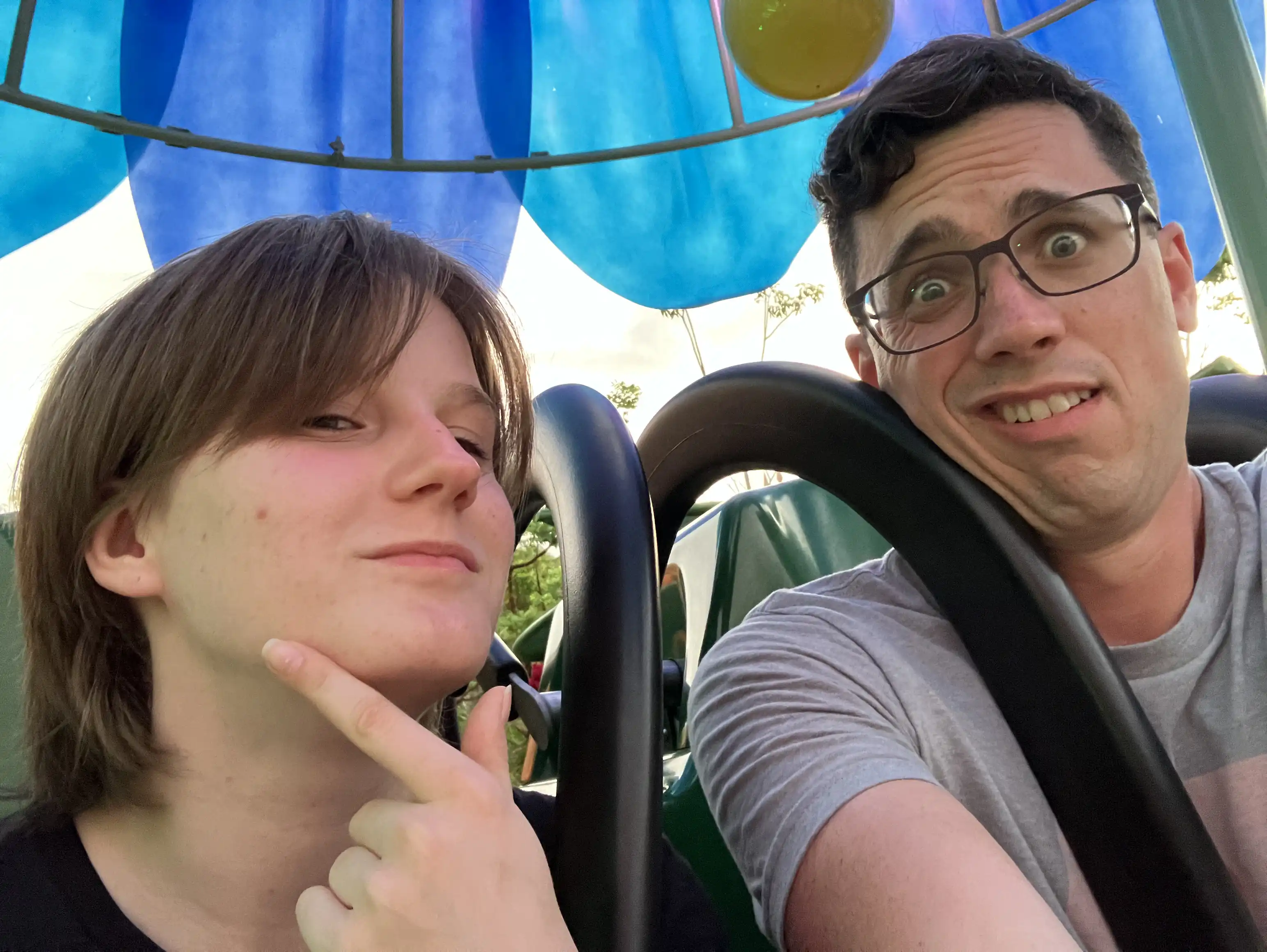 Alex seated on the flower drop with Viktoria. He looks worried.