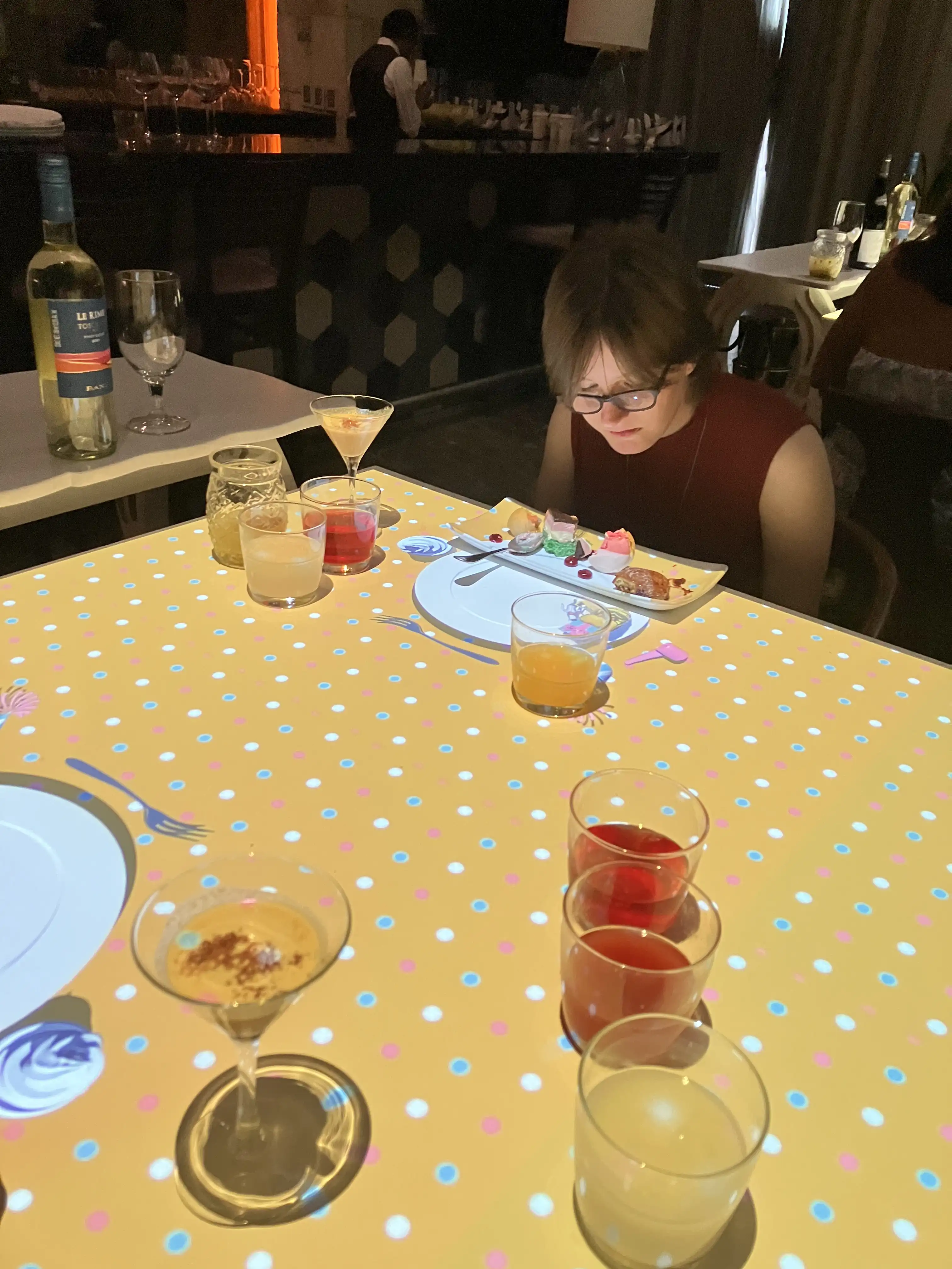 Viktoria deciding which of the four desserts to sample first.